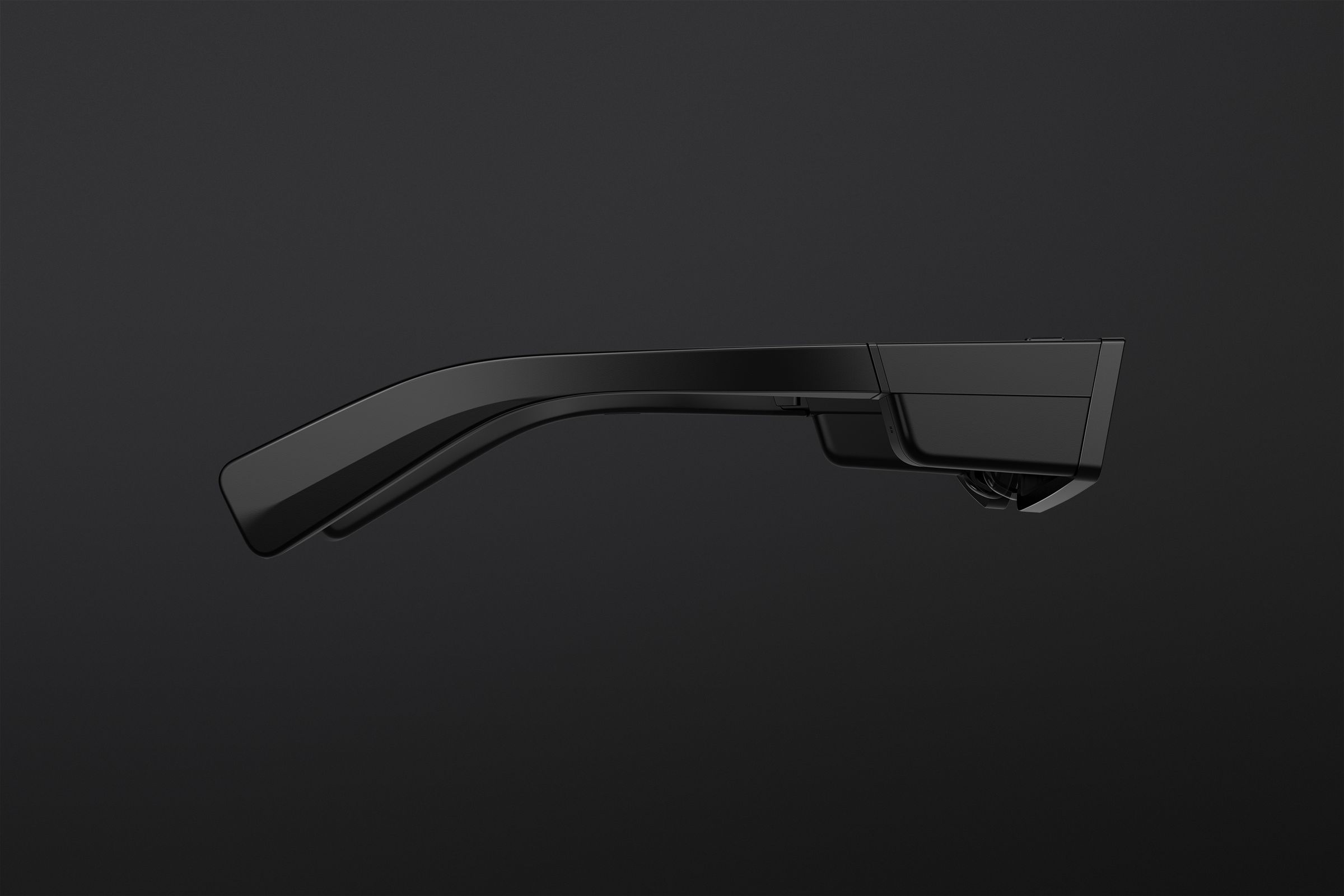 A side view showing the right temple of the glasses. A touchpad beside the lens lets you control the Spectacles.