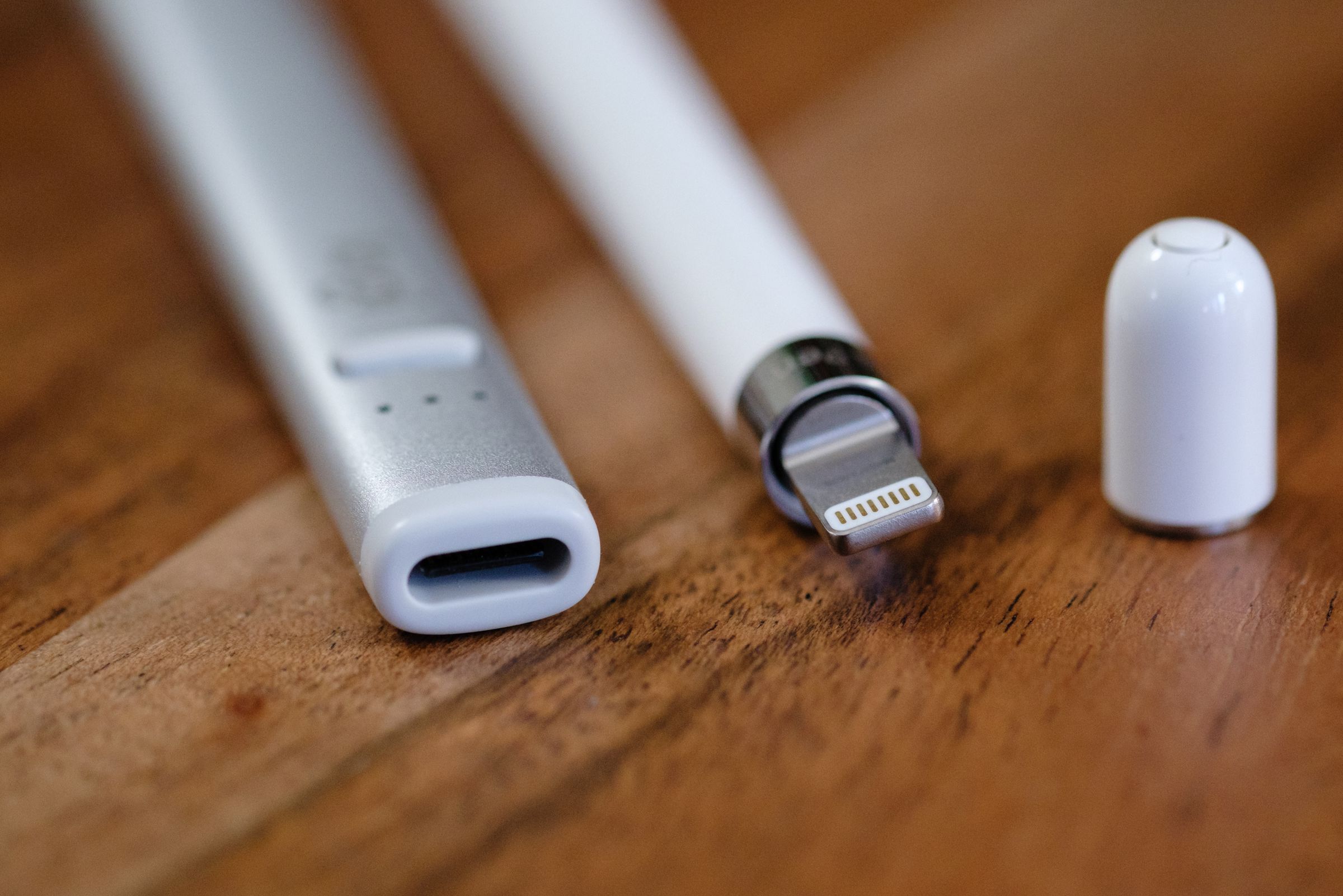 A close-up of the USB-C port of the Logitech Crayon and the lightning plug of the 1st generation Apple Pencil.