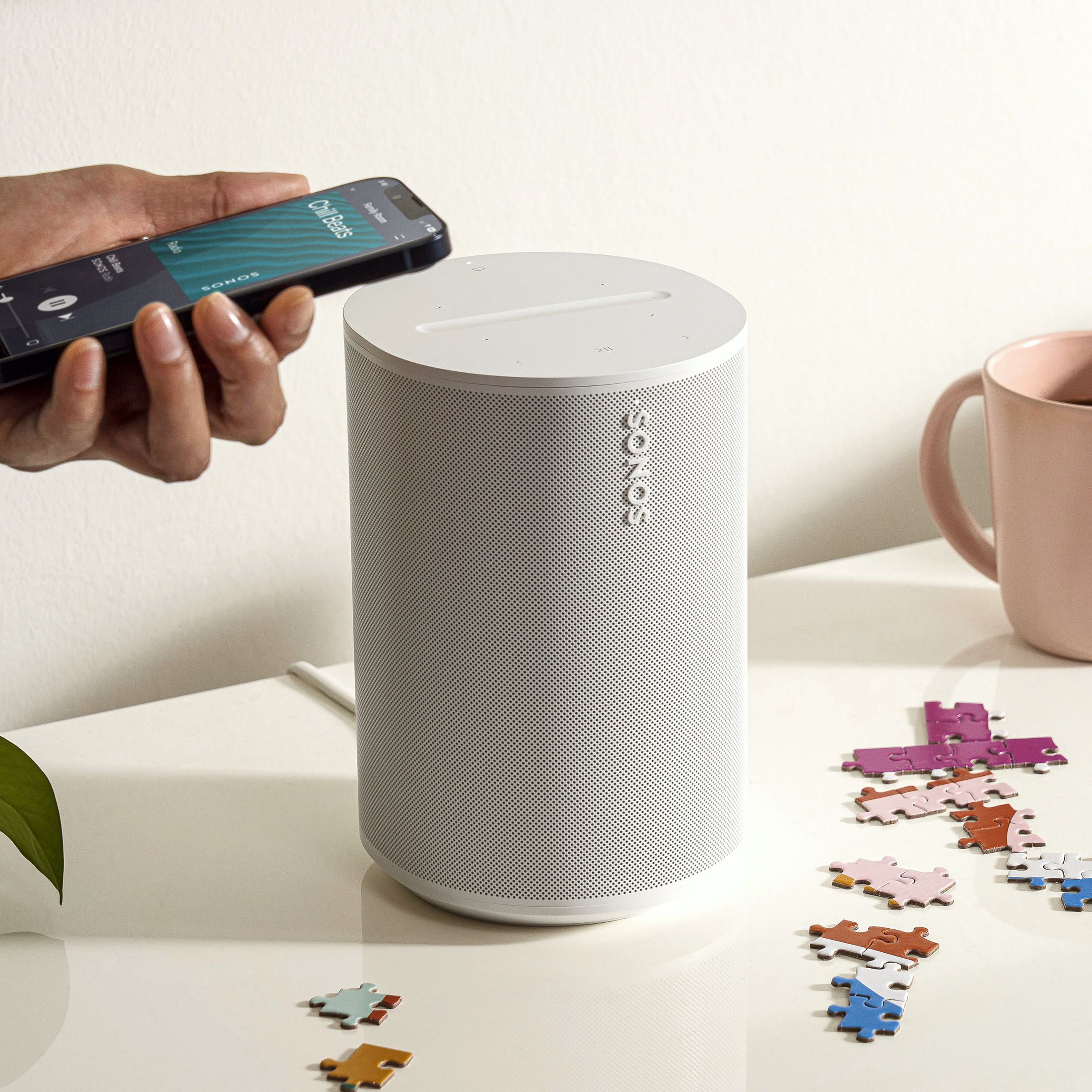 A marketing image of the Sonos Era 100 on a white table.