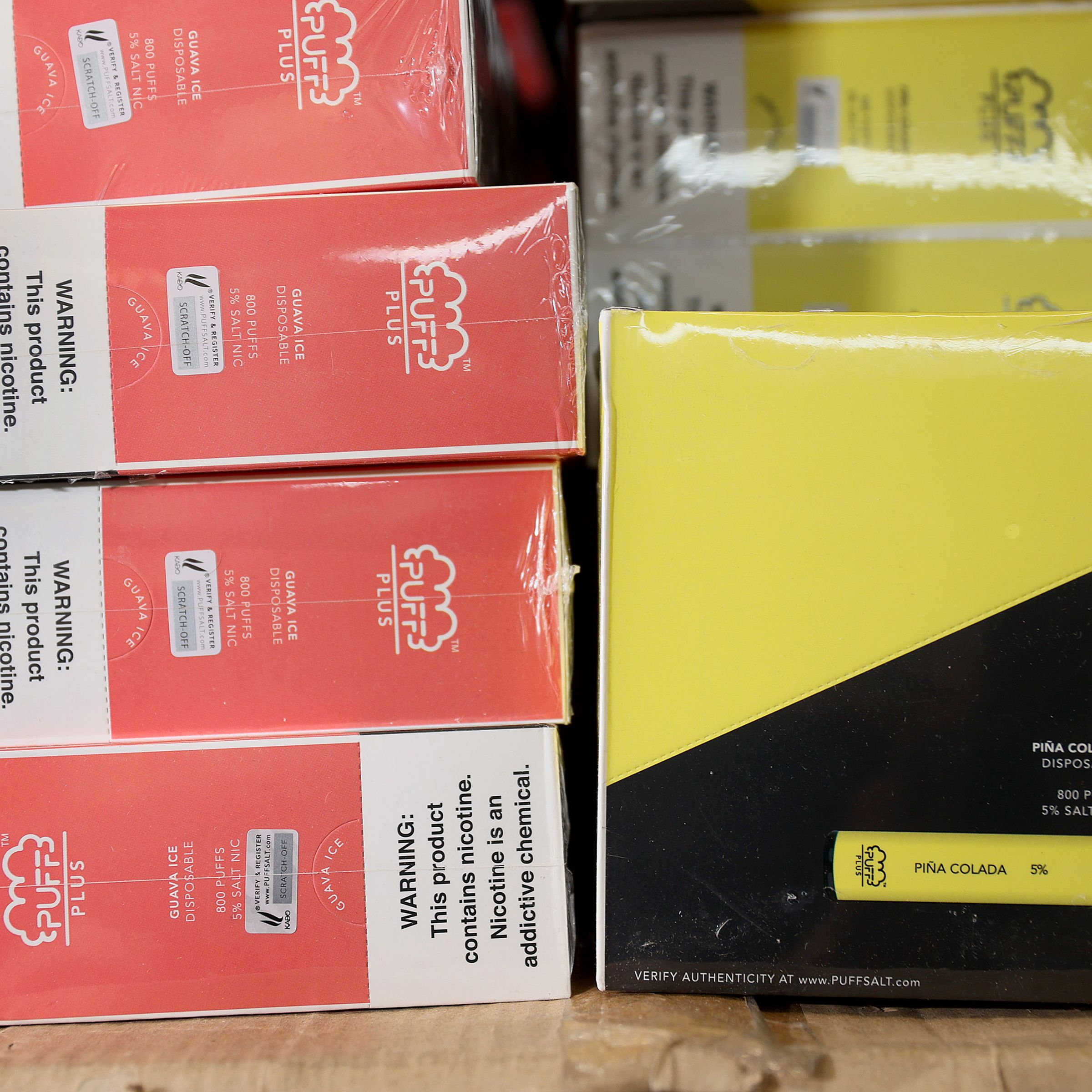 Pink and yellow boxes of Puff Bar e-cigarettes.