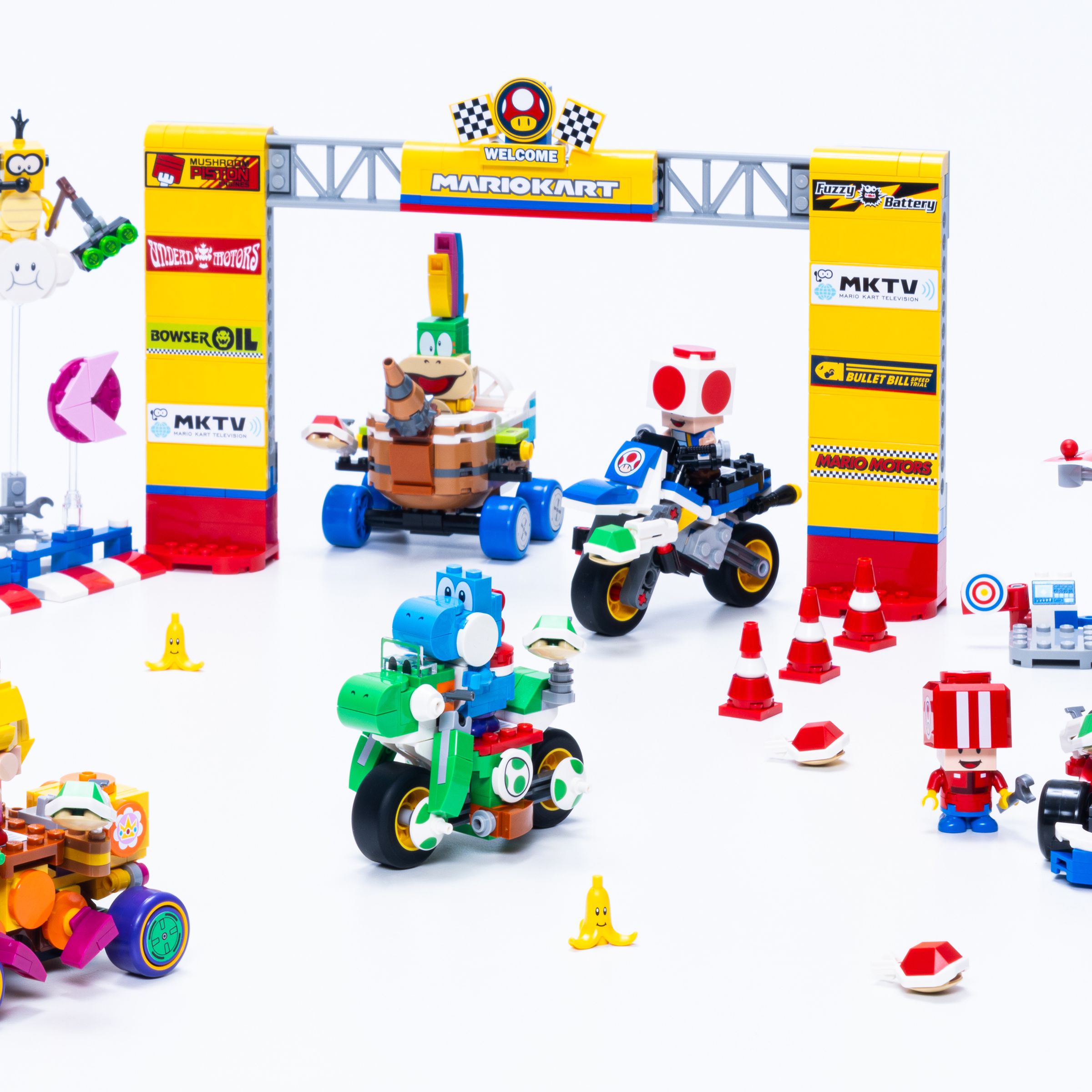 Several Lego Super Mario: Mario Kart vehicles posed against a starting gate.