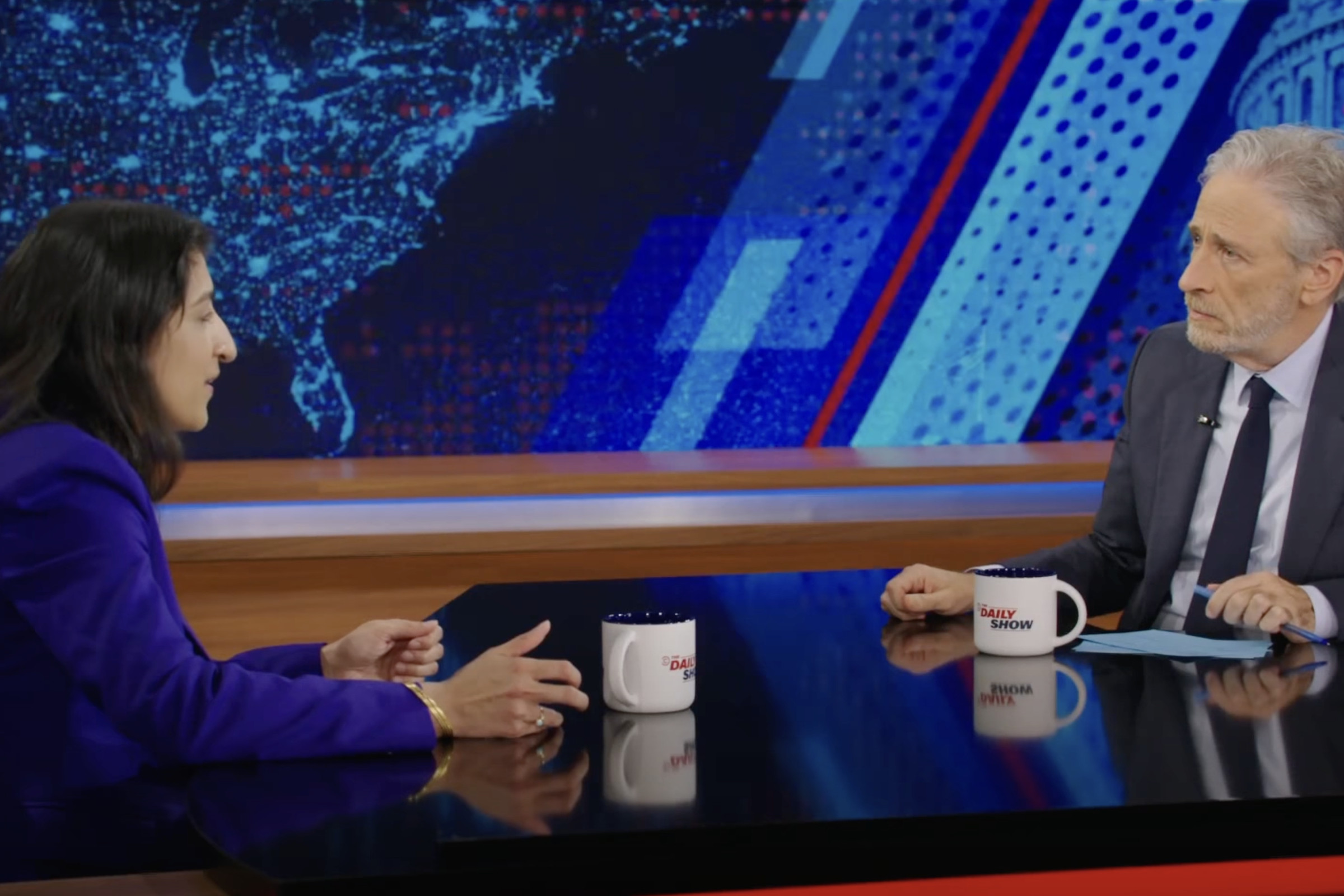 A screenshot showing Jon Stewart sitting across from Lina Khan during his Daily Show interview.