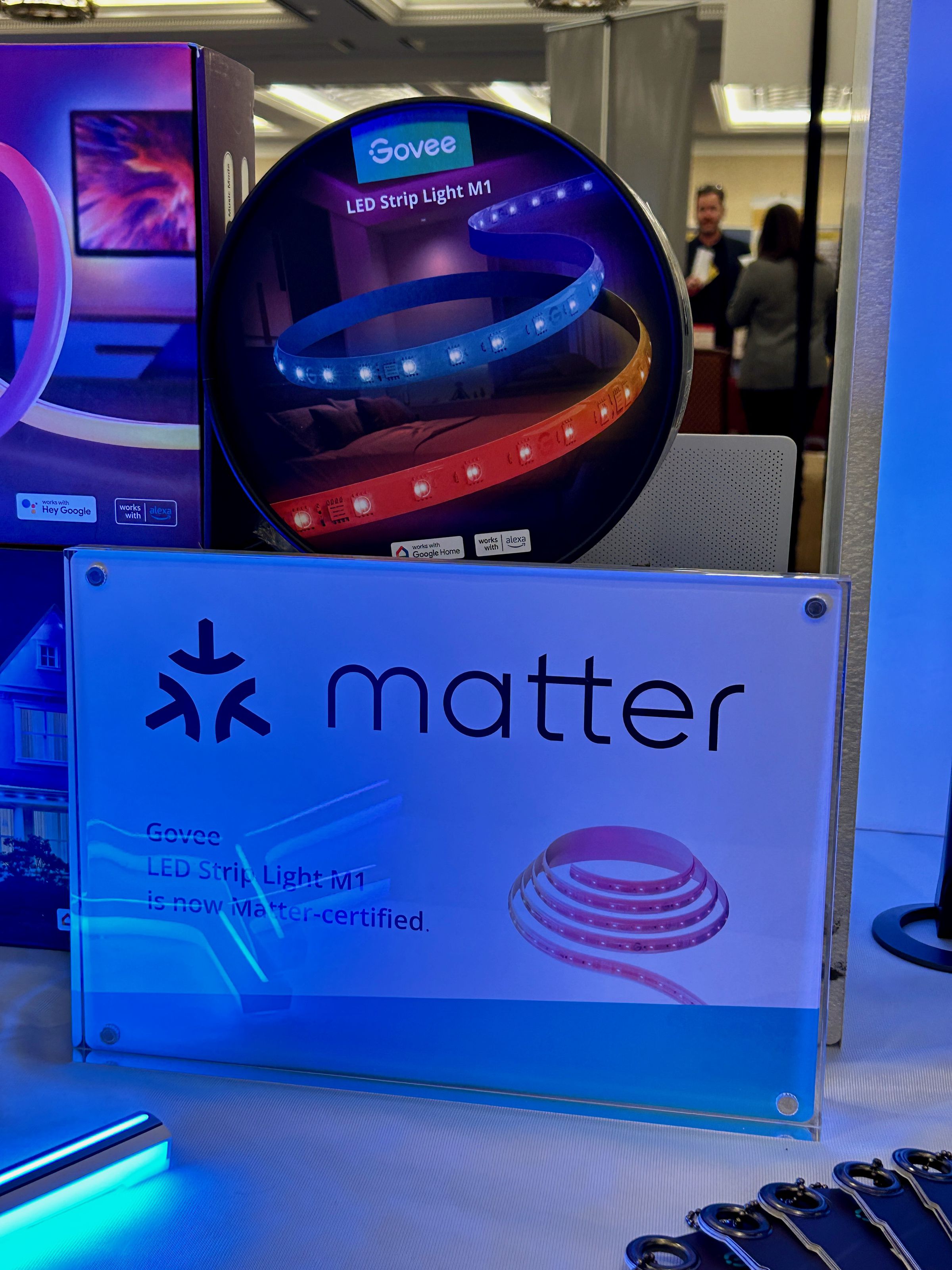 A large sign that says Matter and shows a picture of a light strip in front of a box for a Govee light strip.