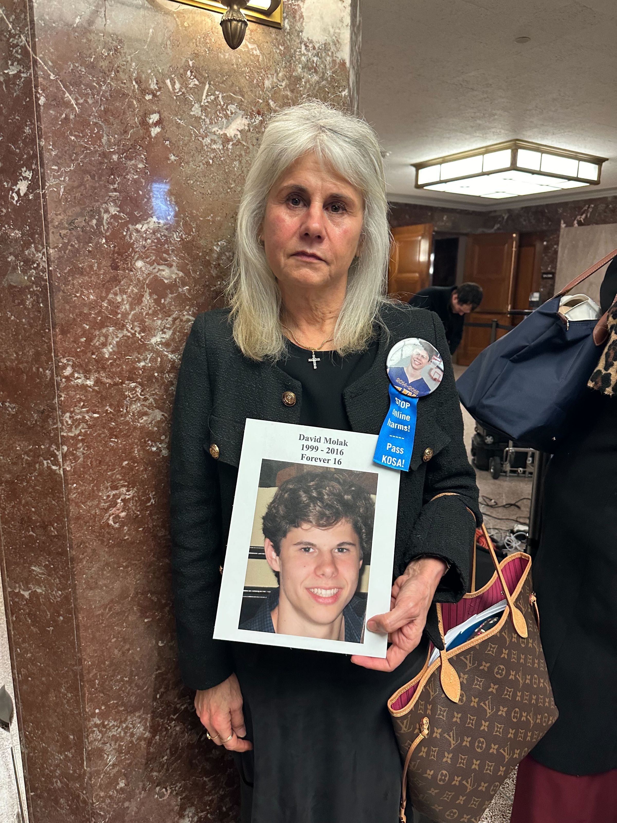Maurine Molak holds a photo of her son David, who she said died by suicide after being cyberbullied on Instagram.