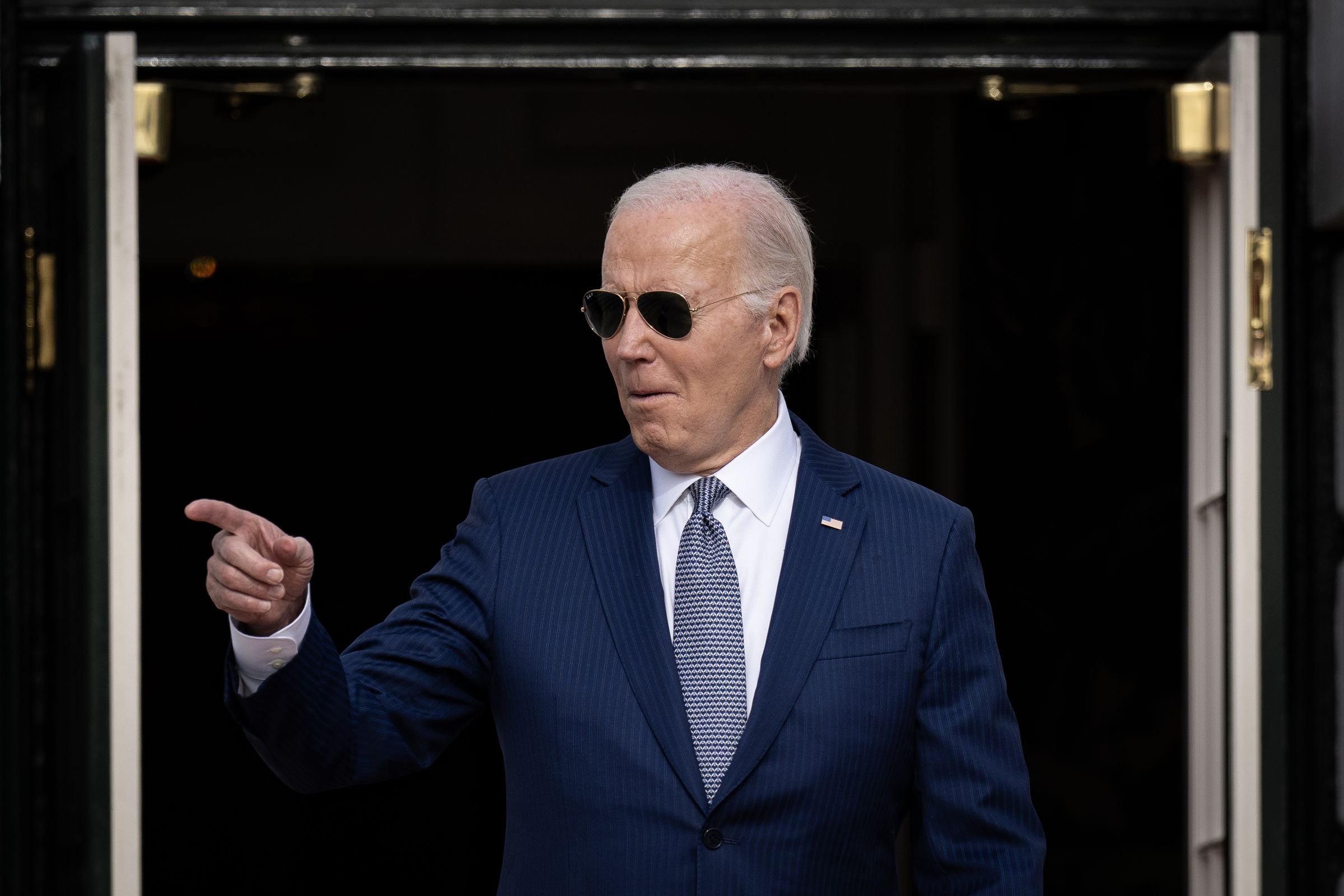 Joe Biden pointing at someone off-camera.