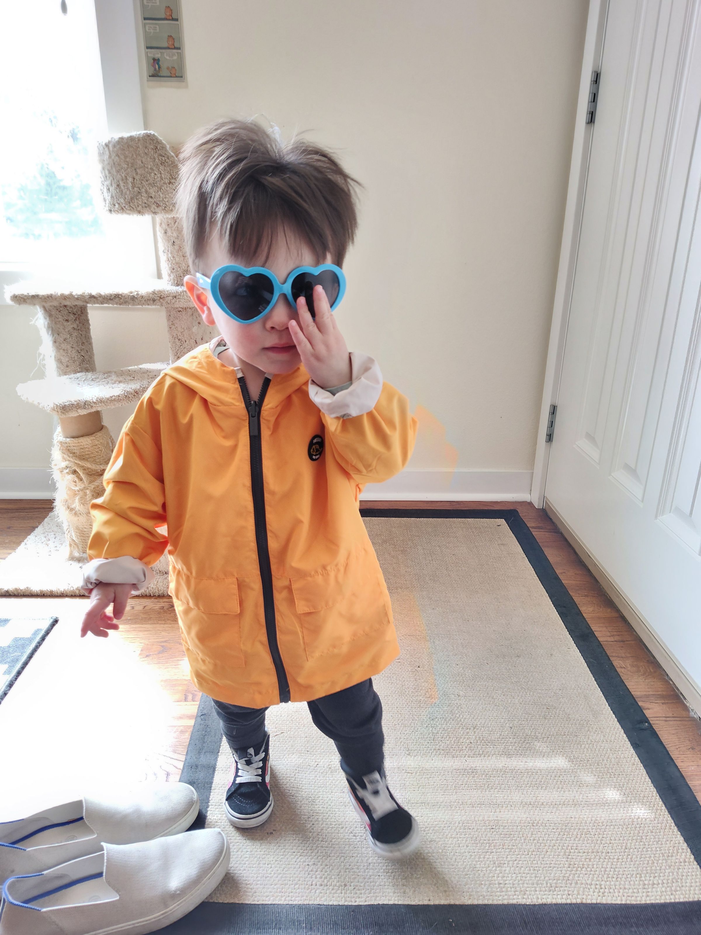 Photo of a young child wearing a yellow jacket with digital artifacts near elbow and side.