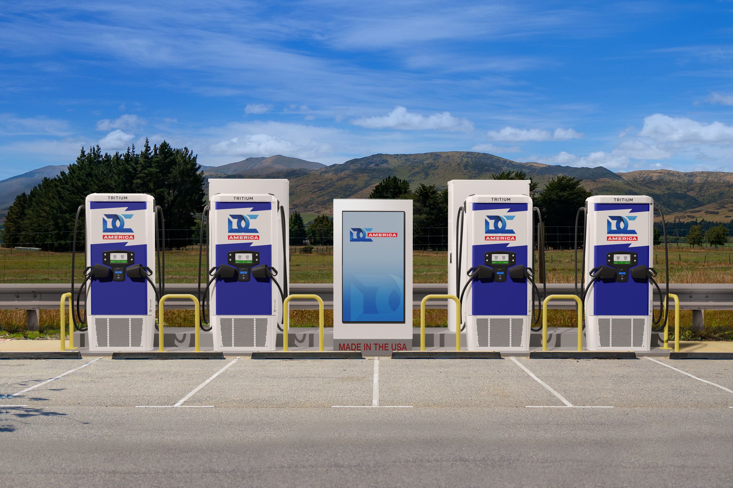 This rendering shows four Tritium charging stations in a line, each with two plugs and cables, two large transformer units behind the units, and a large screen in between two pairs of stations. The background is mountainous, with a partly cloudy sky.
