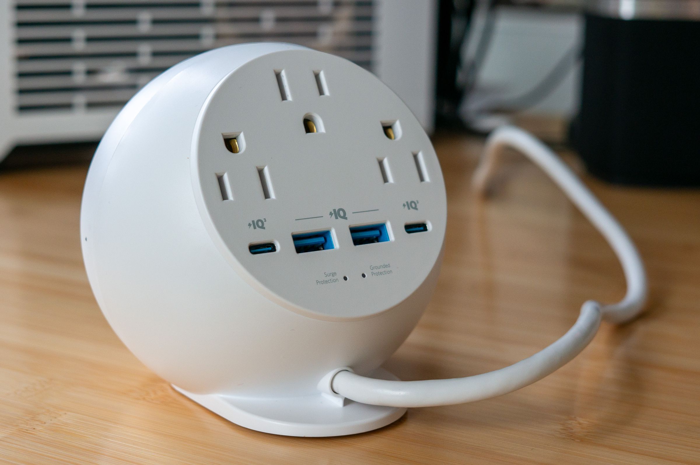 Rear view of the Anker 8-in-1 orb showing three AC outlets, two USB-A, and two USB-C ports. 