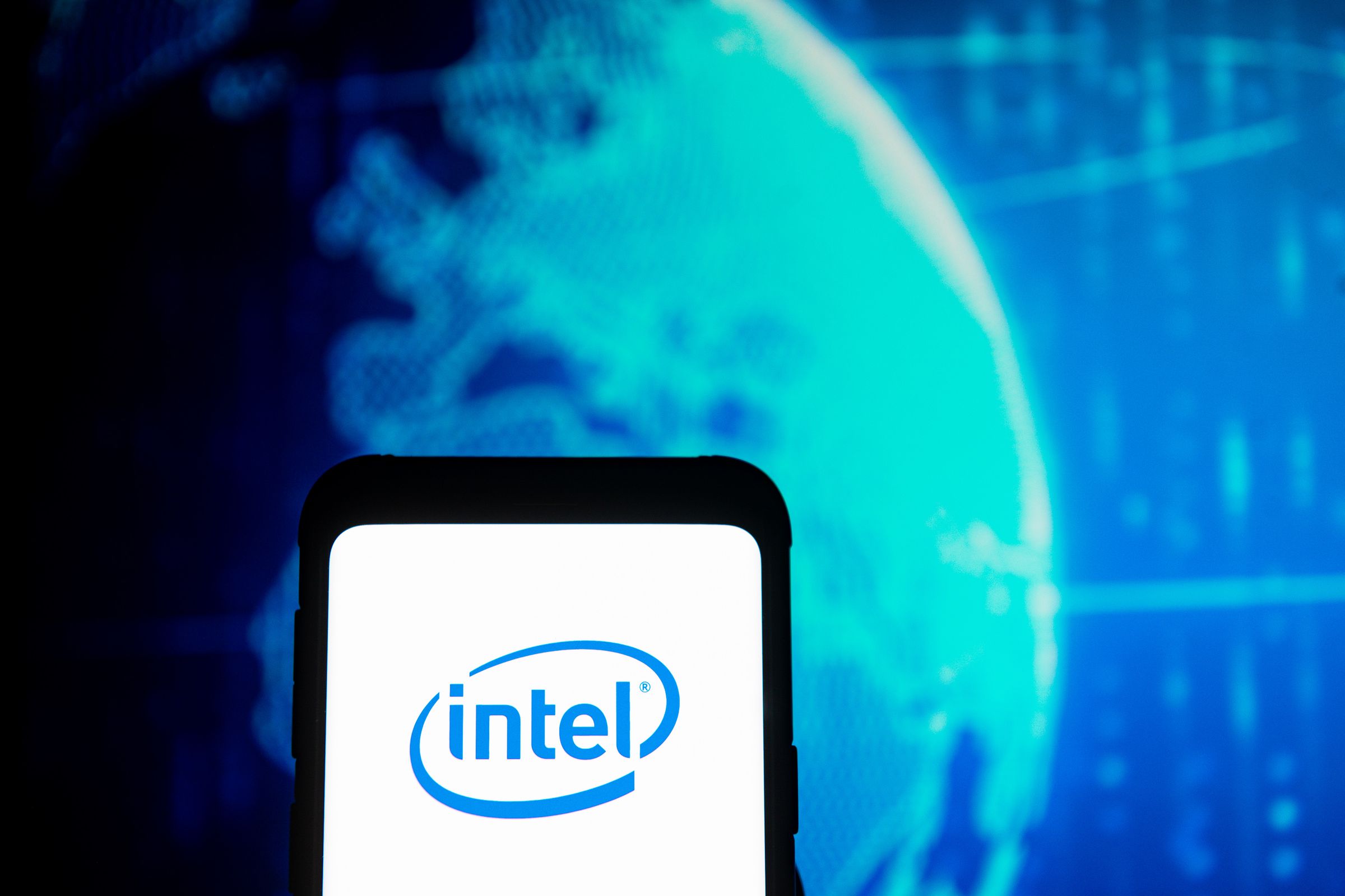 In this photo illustration an Intel logo seen displayed on a...