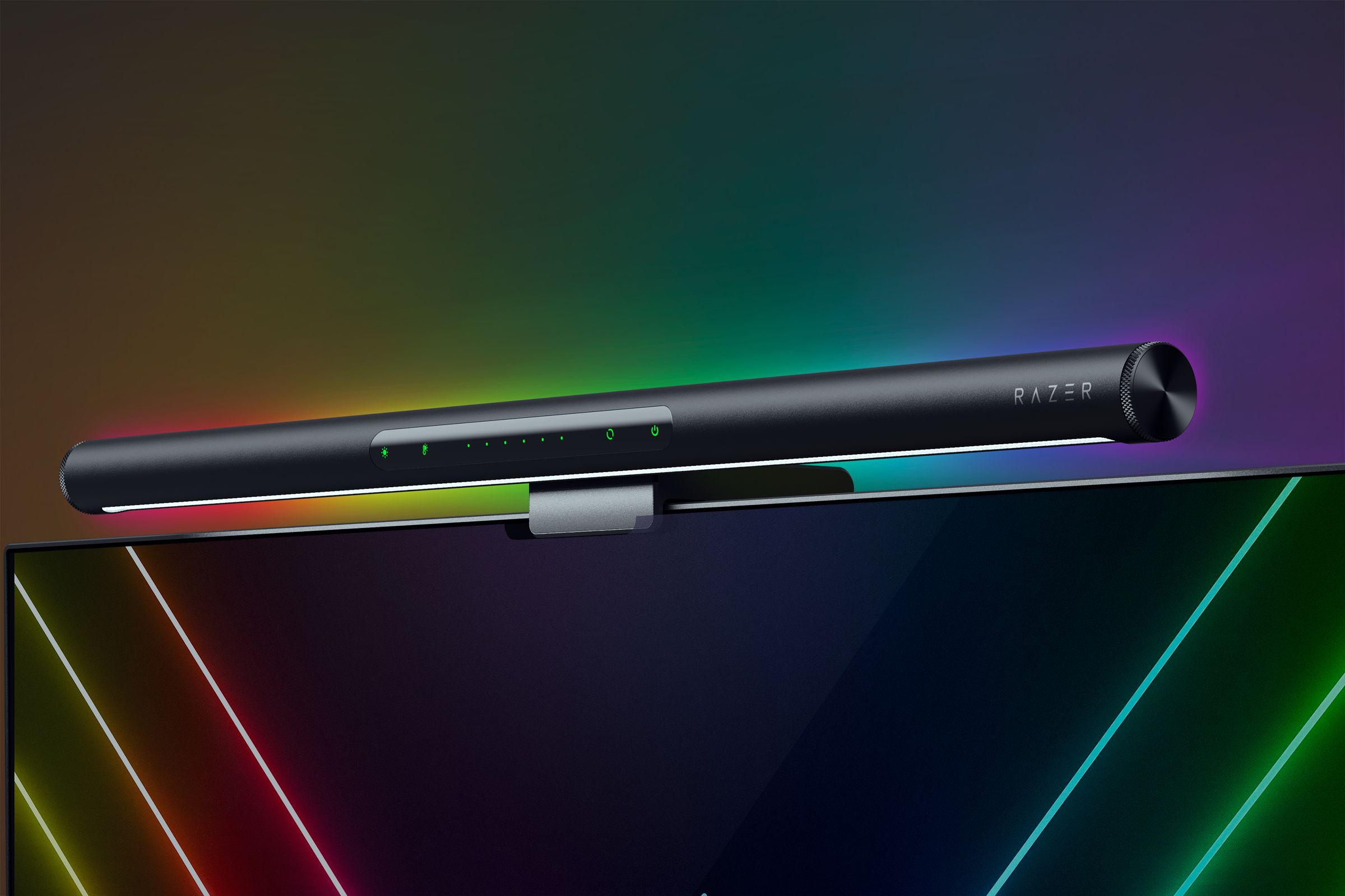 Rendering of a monitor light bar with a white LED strip on the front underside and RGB lighting visible from the back. It is perched on a monitor in front of a black background.