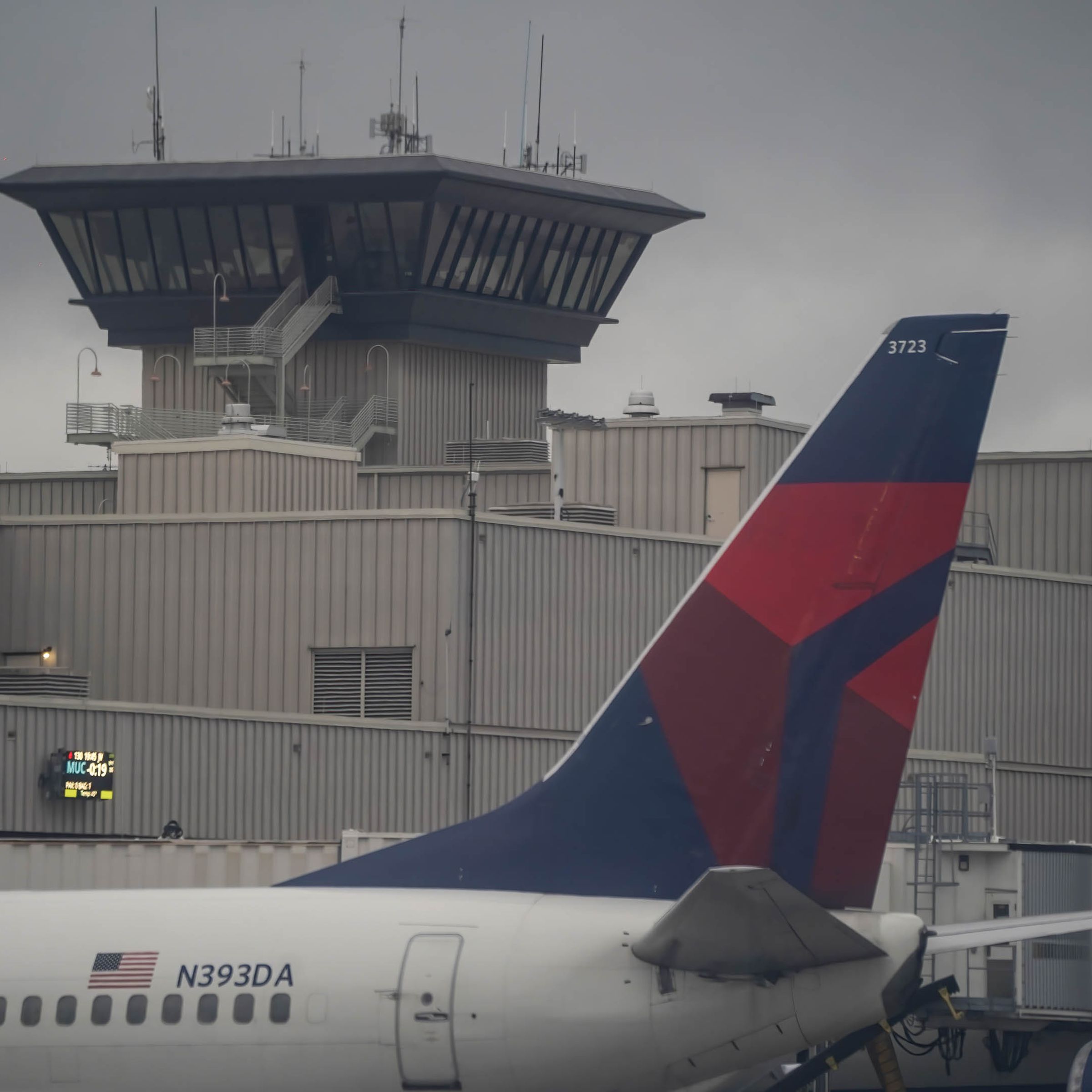 A Delta Air Lines airplane sits at an airport gate.