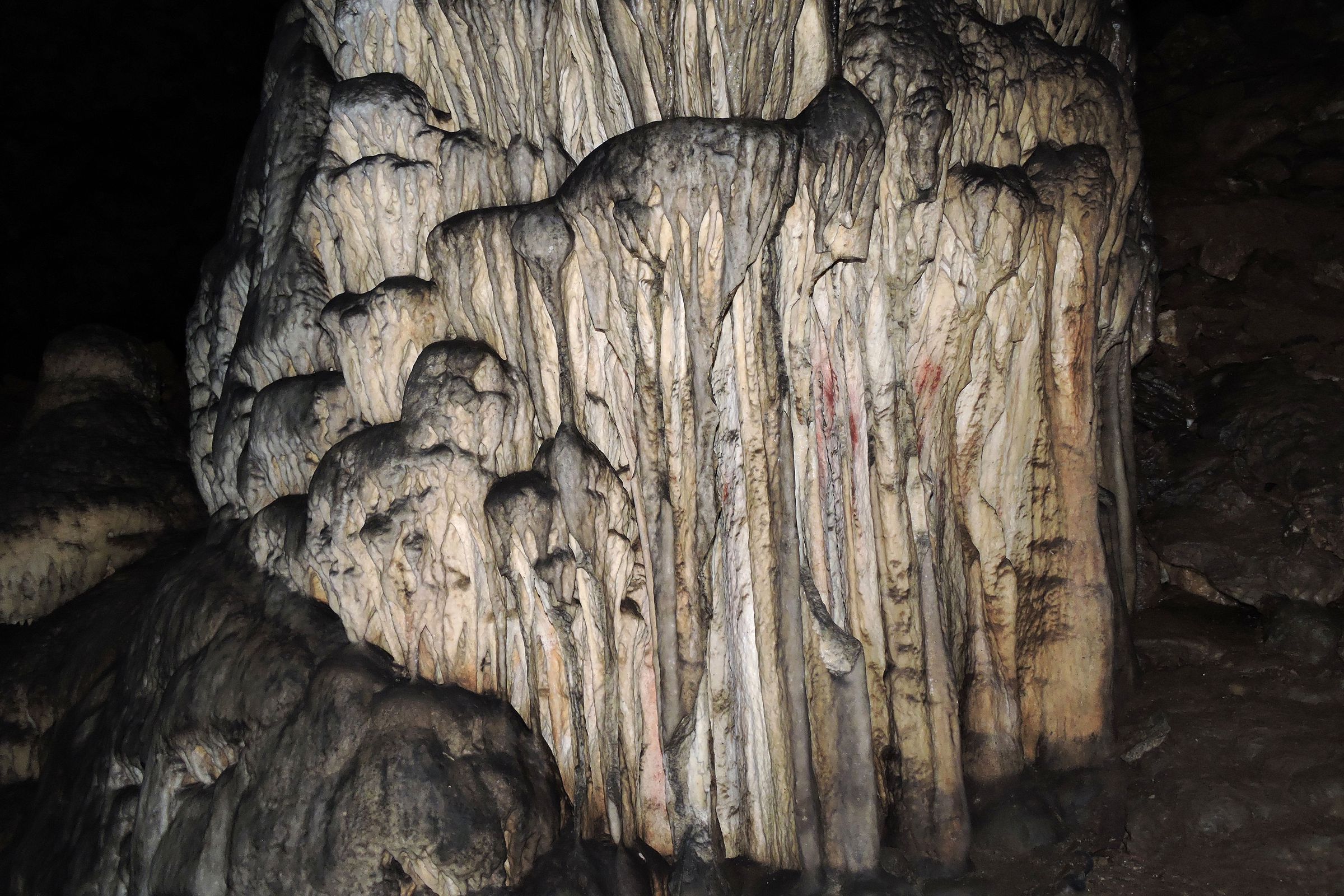 This curtain of stalactites in Ardales cave in Spain was painted with red pigment more than 65,000 years ago — then again 45,000 years ago.