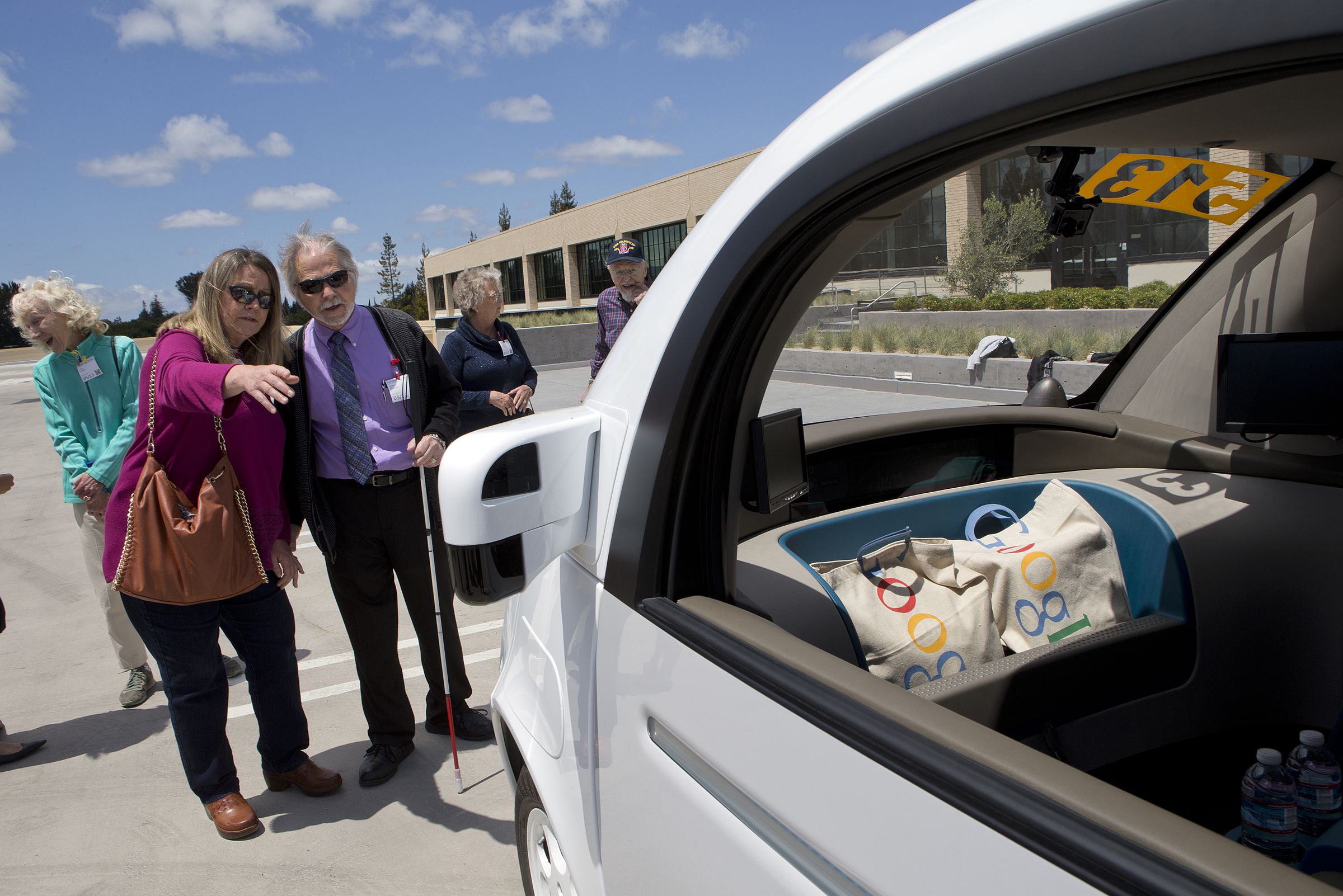 From background left, Judy Arvidson and Steve Mahan of the Santa Clara Valley Blind Center check out the two-seater prototype of Google’s self-driving car at Google in Mountain View, Calif., on Wednesday, May 13, 2015. (LiPo Ching/Bay Area News Group)