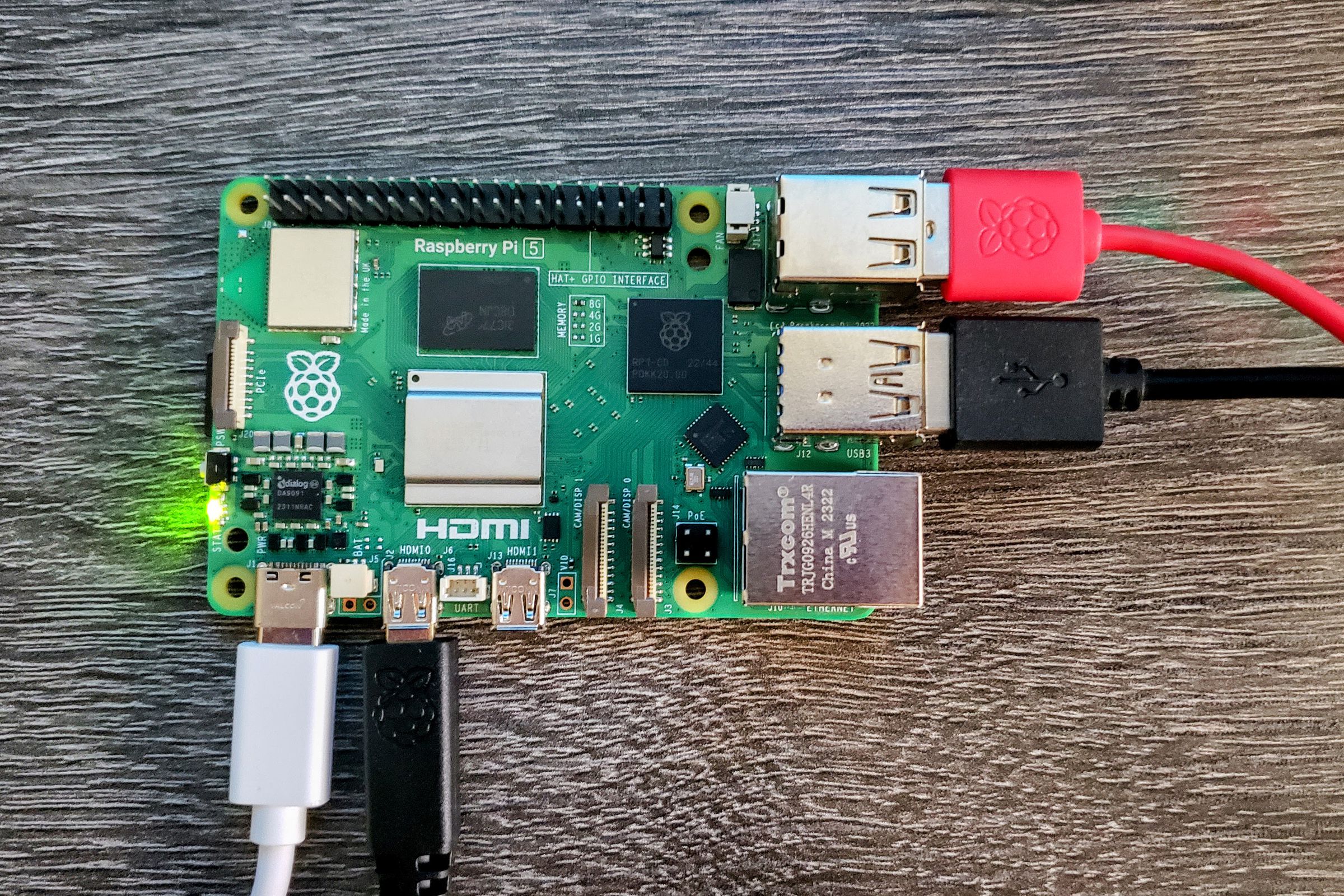 A photo showing the Raspberry Pi 5 with USB cables and a micro HDMI cable plugged in