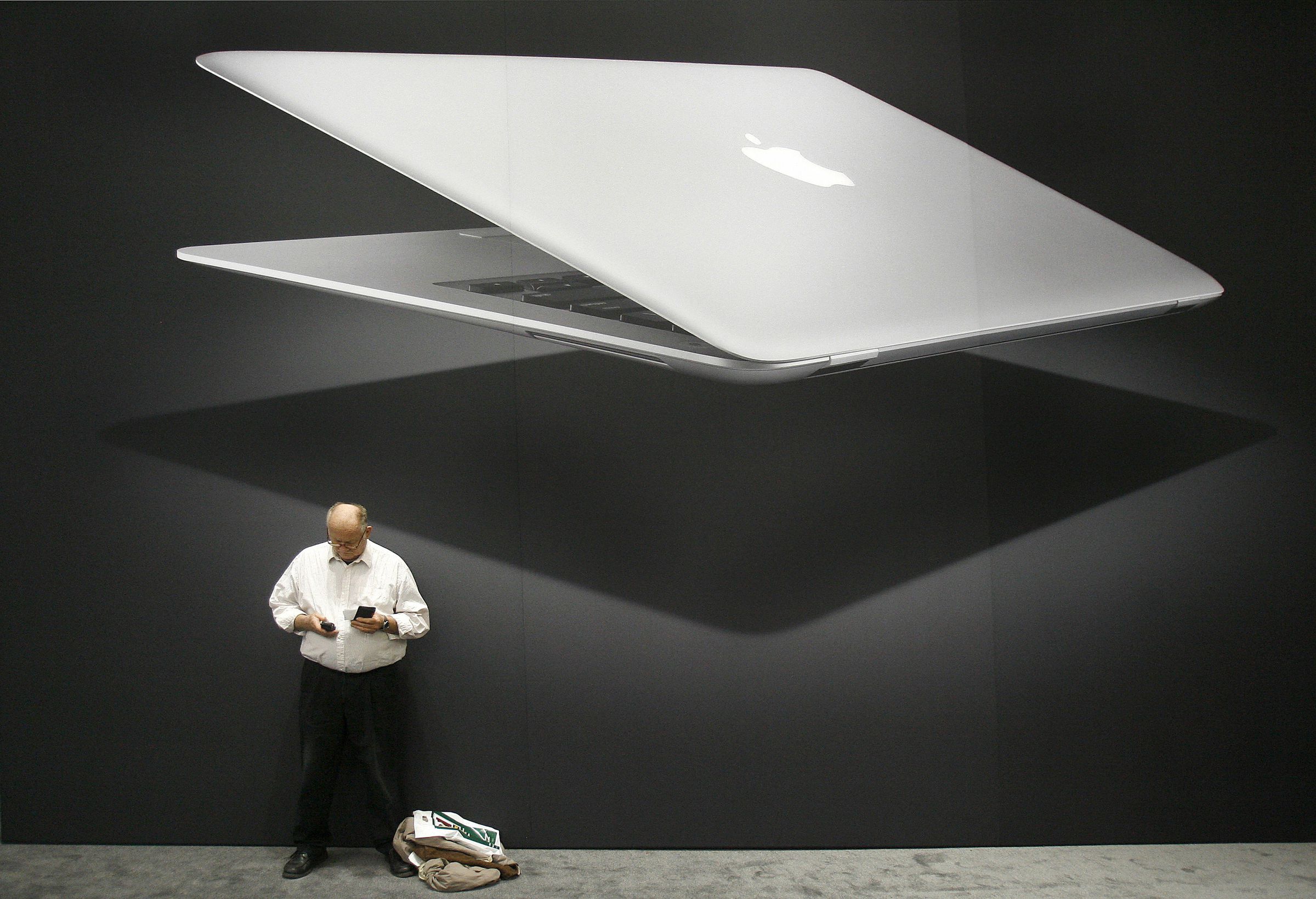 A MacWorld attendee stands next to a gia