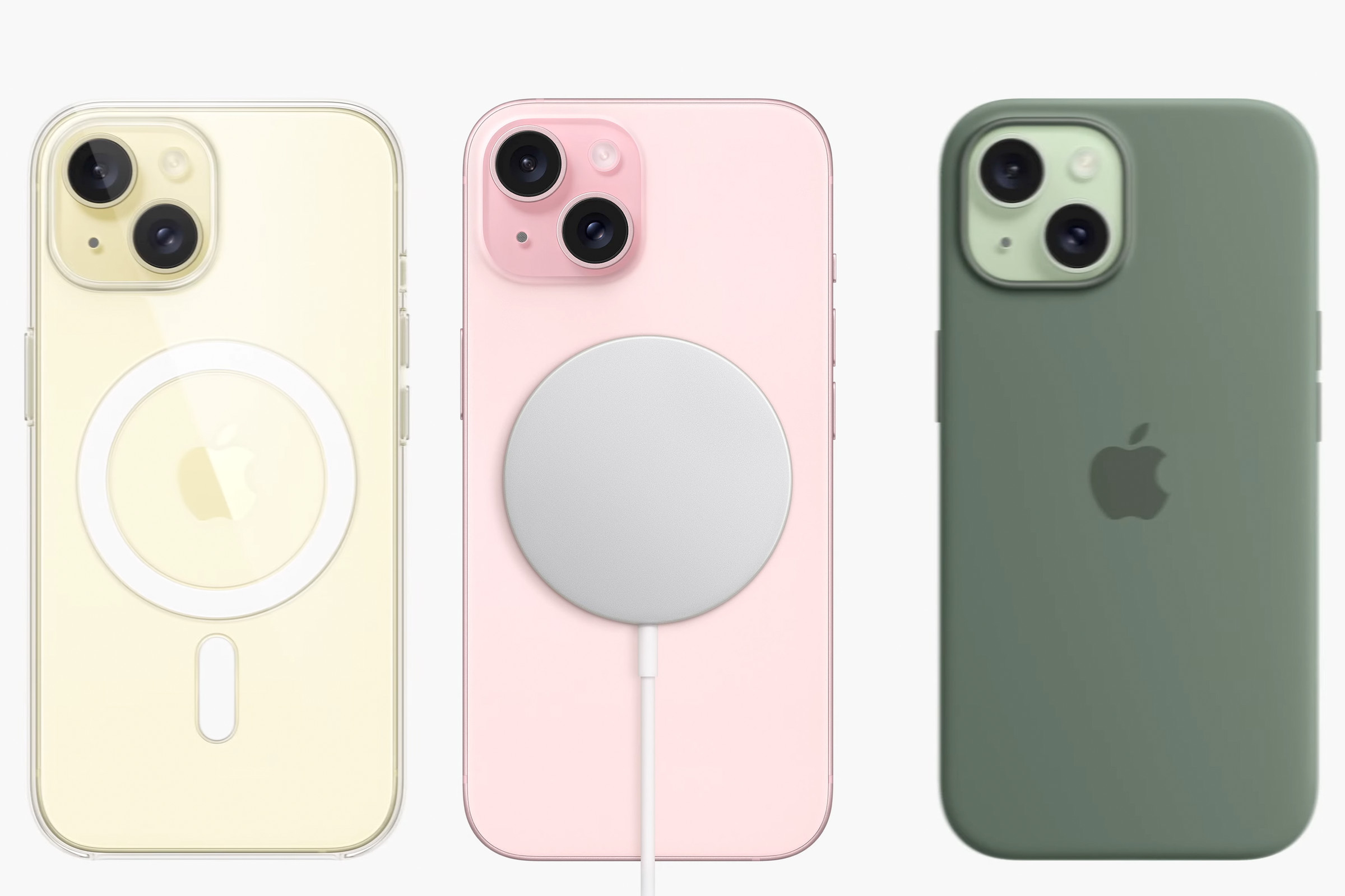 Rear shot of three iPhone 15 models: Yellow with a clear MagSafe case, pink with a magnetic charging puck on the back, and green with a green FineWoven case.