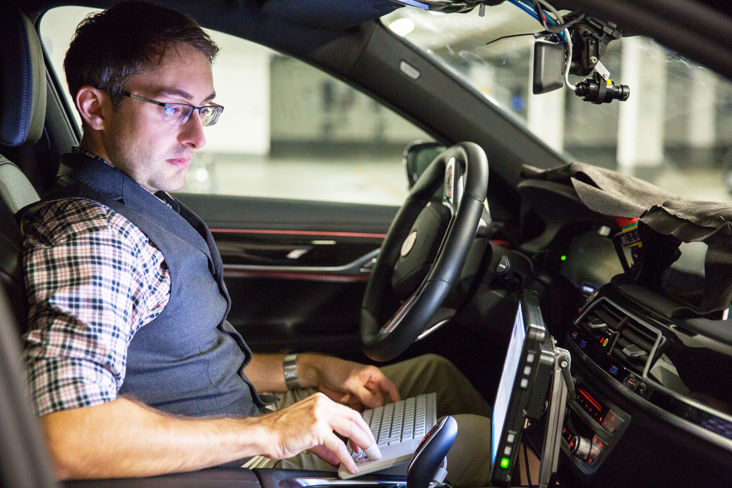 BMW engineer, André Mueller, tests autonomous driving technology in a BMW 7 series sedan.