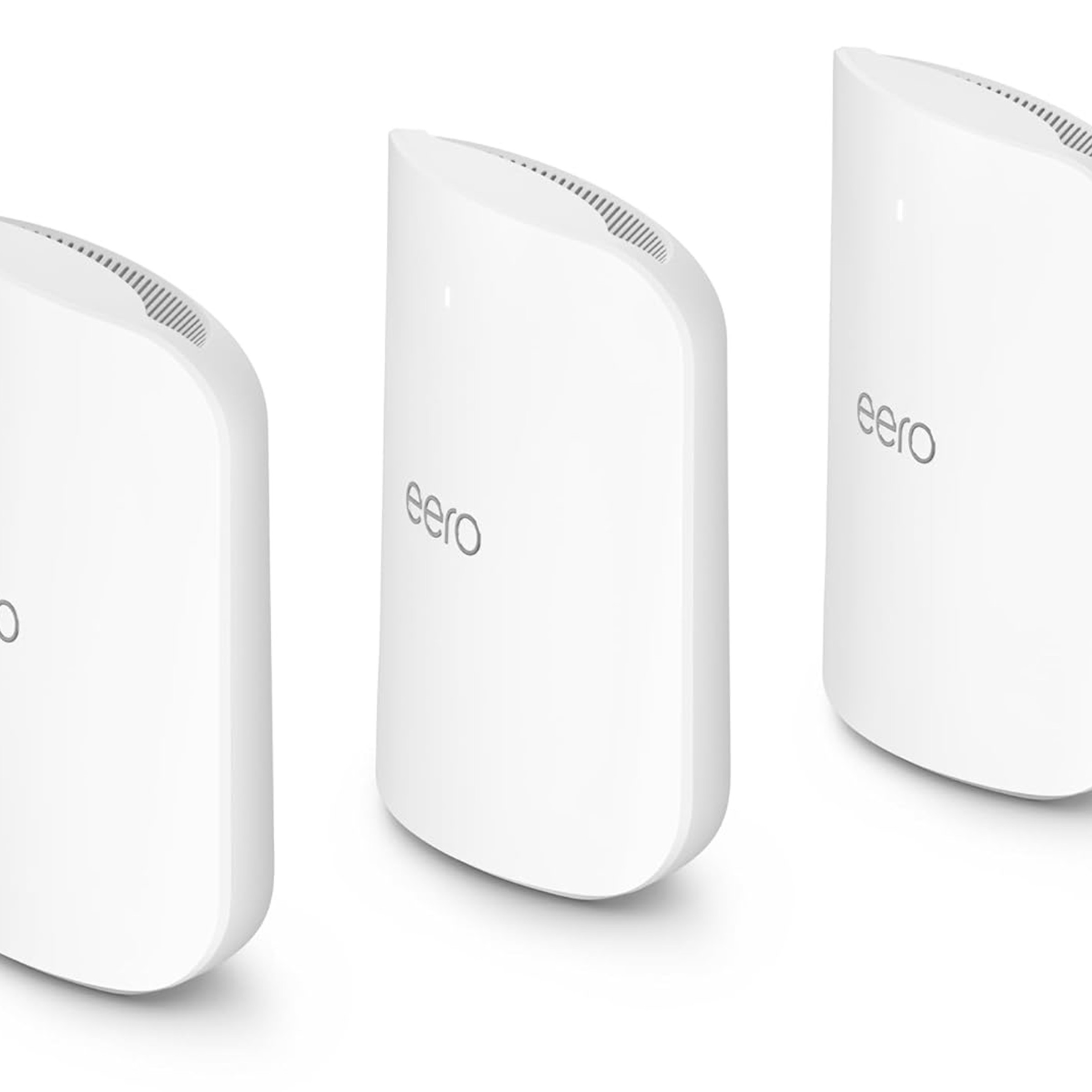A picture of the Eero Max 7 three-pack, all lined up from a three-quarter perspective and spaced apart.