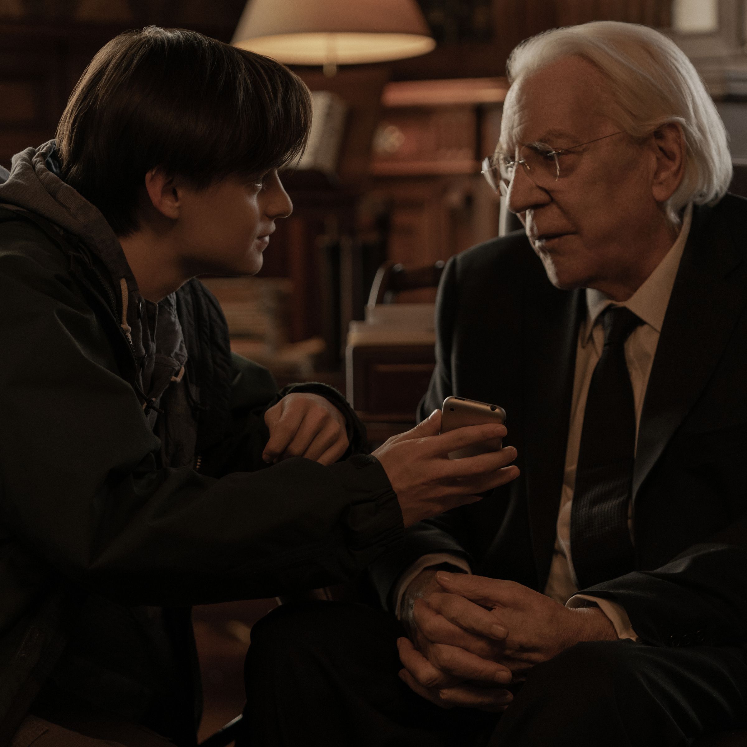 A photo of Jaeden Martell and Donald Sutherland in the Netflix film Mr. Harrigan’s Phone.