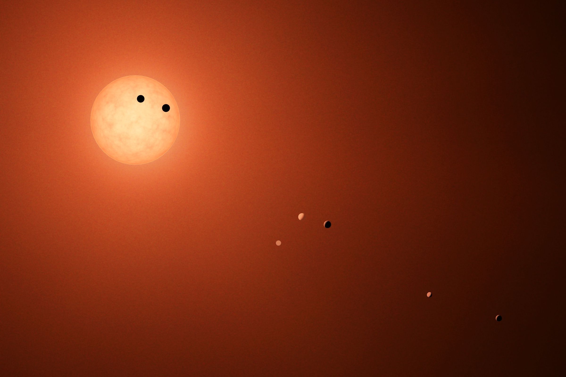 An illustration showing the seven Earth-like planets of Trappist-1, a nearby star system astronomers say will be able to view Earth in transit roughly 1,600 years from now.