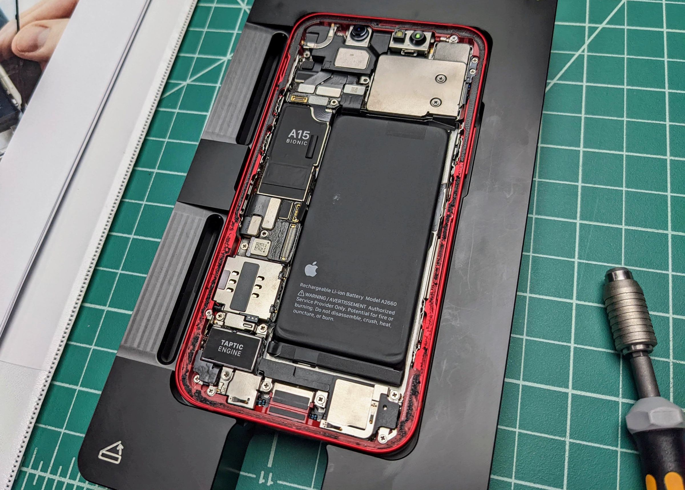 Photo of an iPhone with its battery exposed.