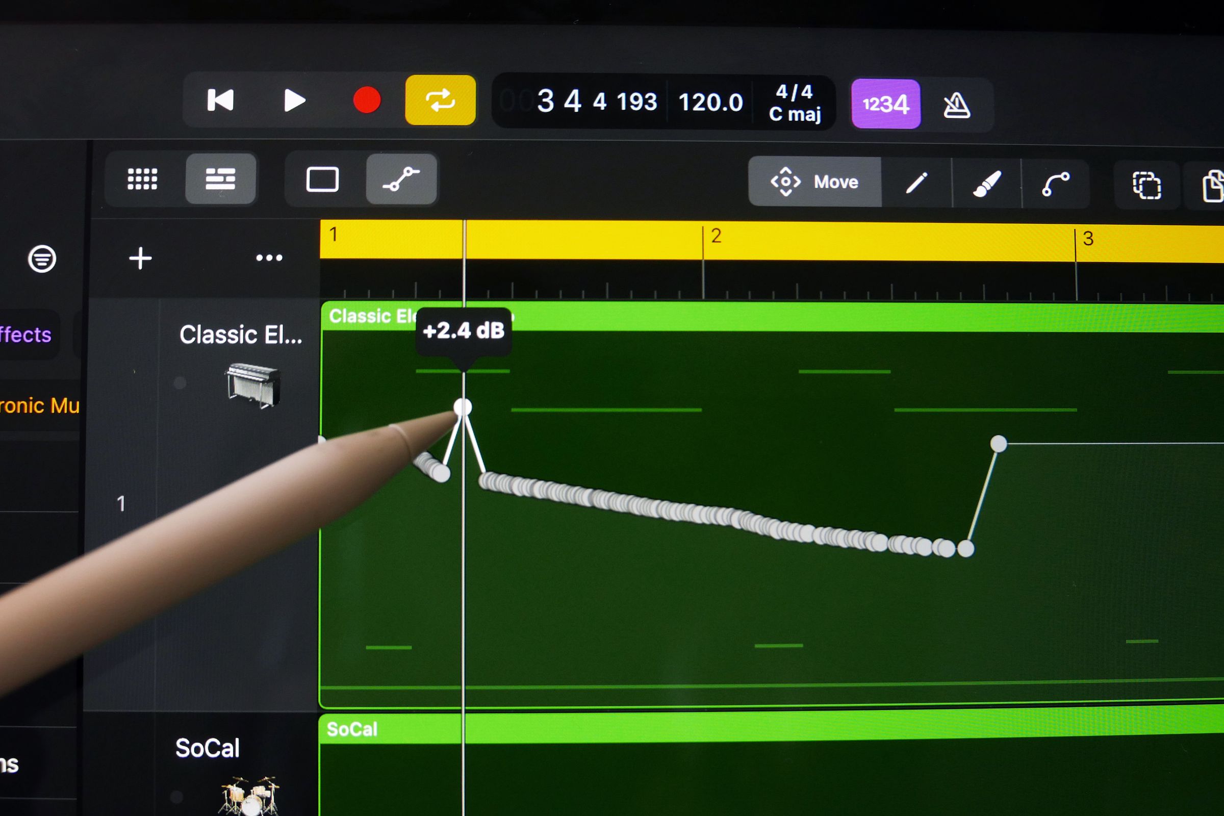 An Apple Pencil on an iPad Pro drawing an automation curve on a piano track
