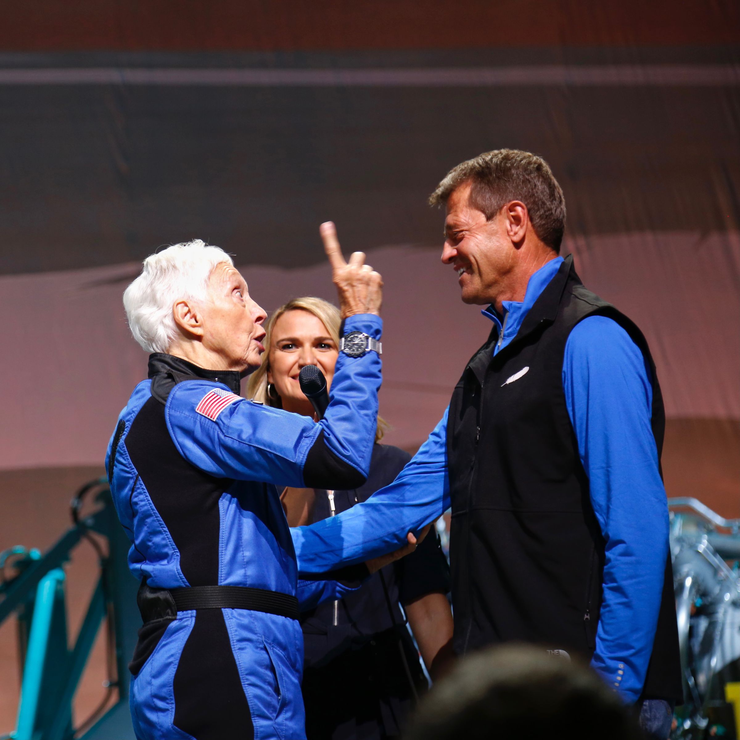 Wally Funk, with former Space Shuttle commander and Blue Origin senior director for mission assurance Jeff Ashby, on stage during a post-mission event.
