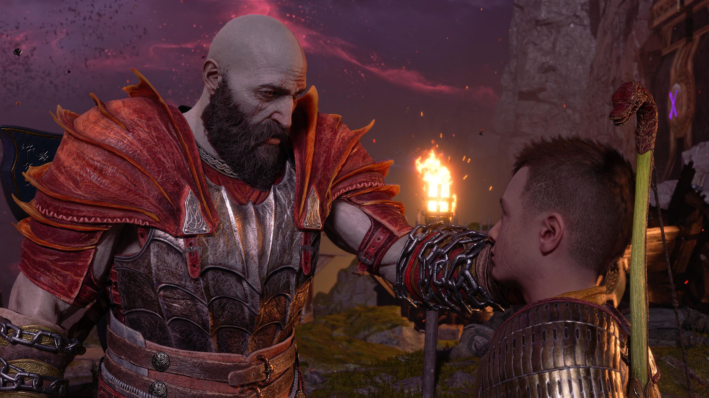 Screenshot of God of War Ragnarok showing Kratos gently touching his son Atreus' face in comfort