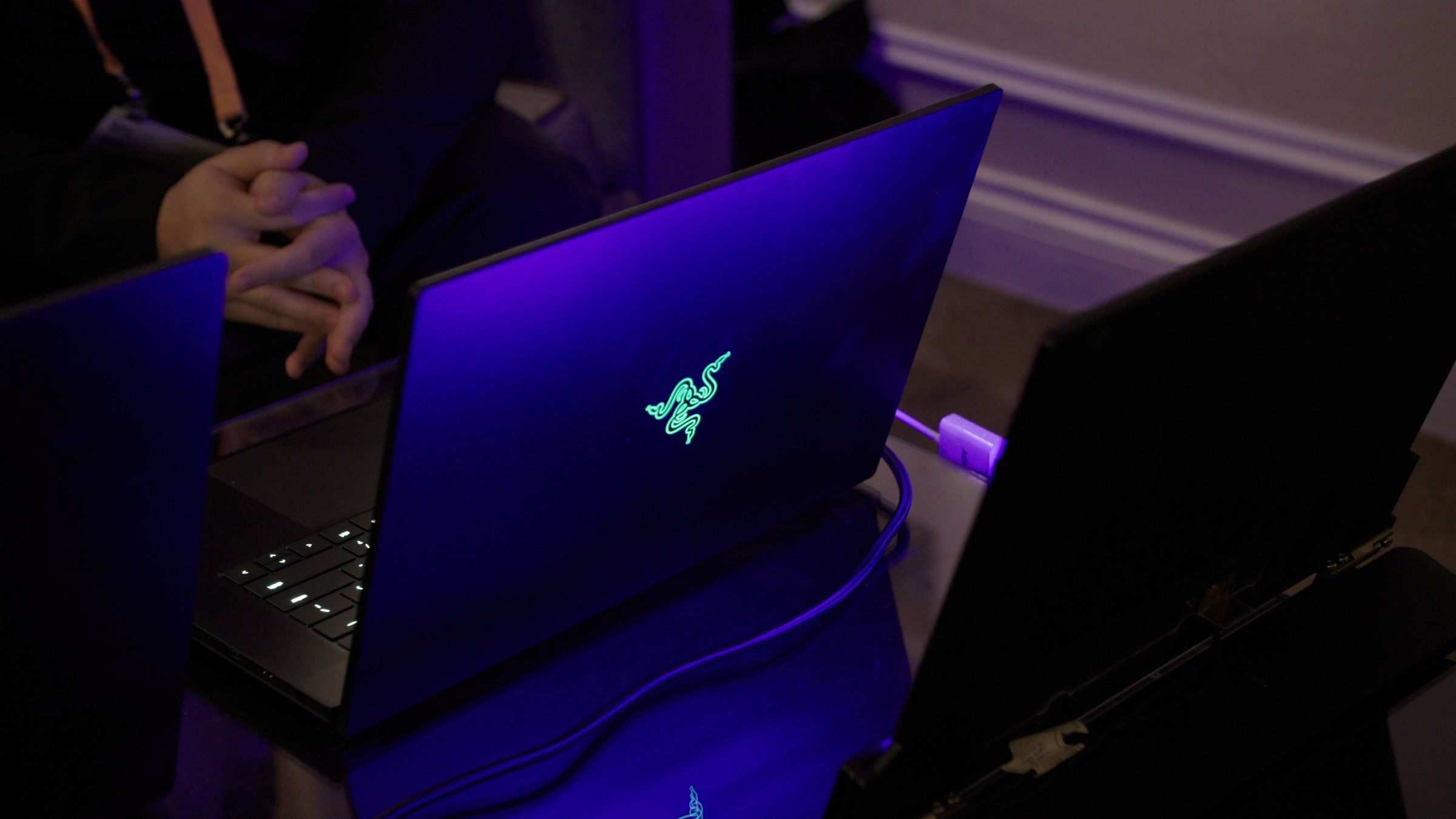 The Razer Blade 16 seen from the back on a dark table.