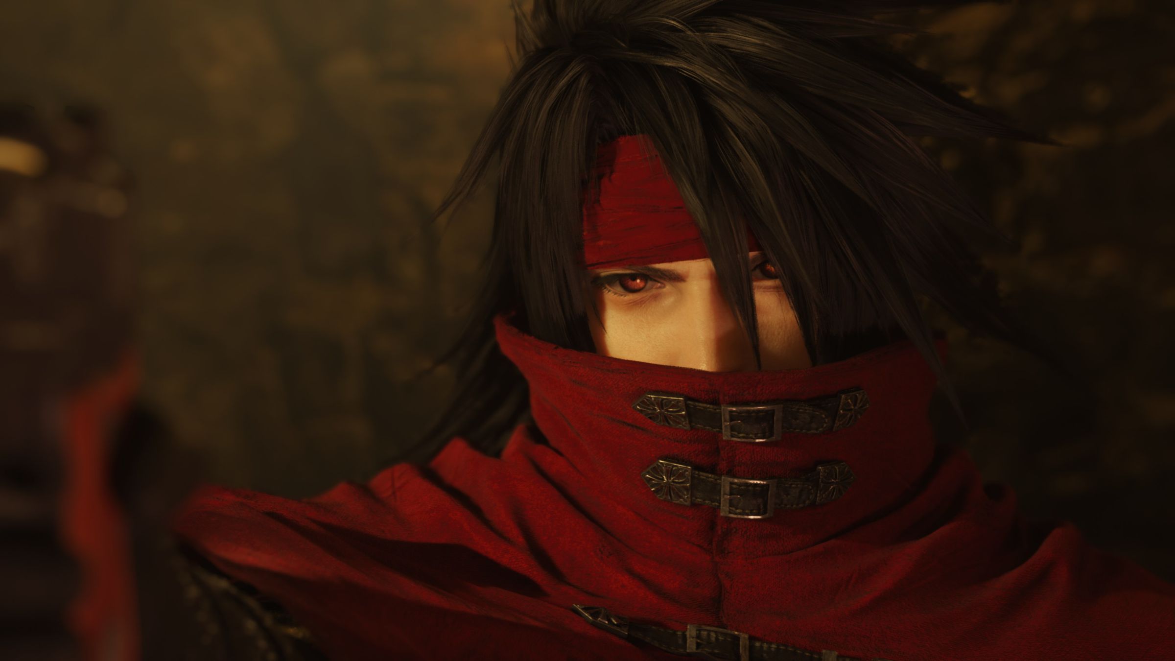 Screenshot from Final Fantasy VII Rebirth featuring a close-up of Vincent Valentine, a light-skinned man with black hair, red eyes, and a deep red cowl that covers half his face.
