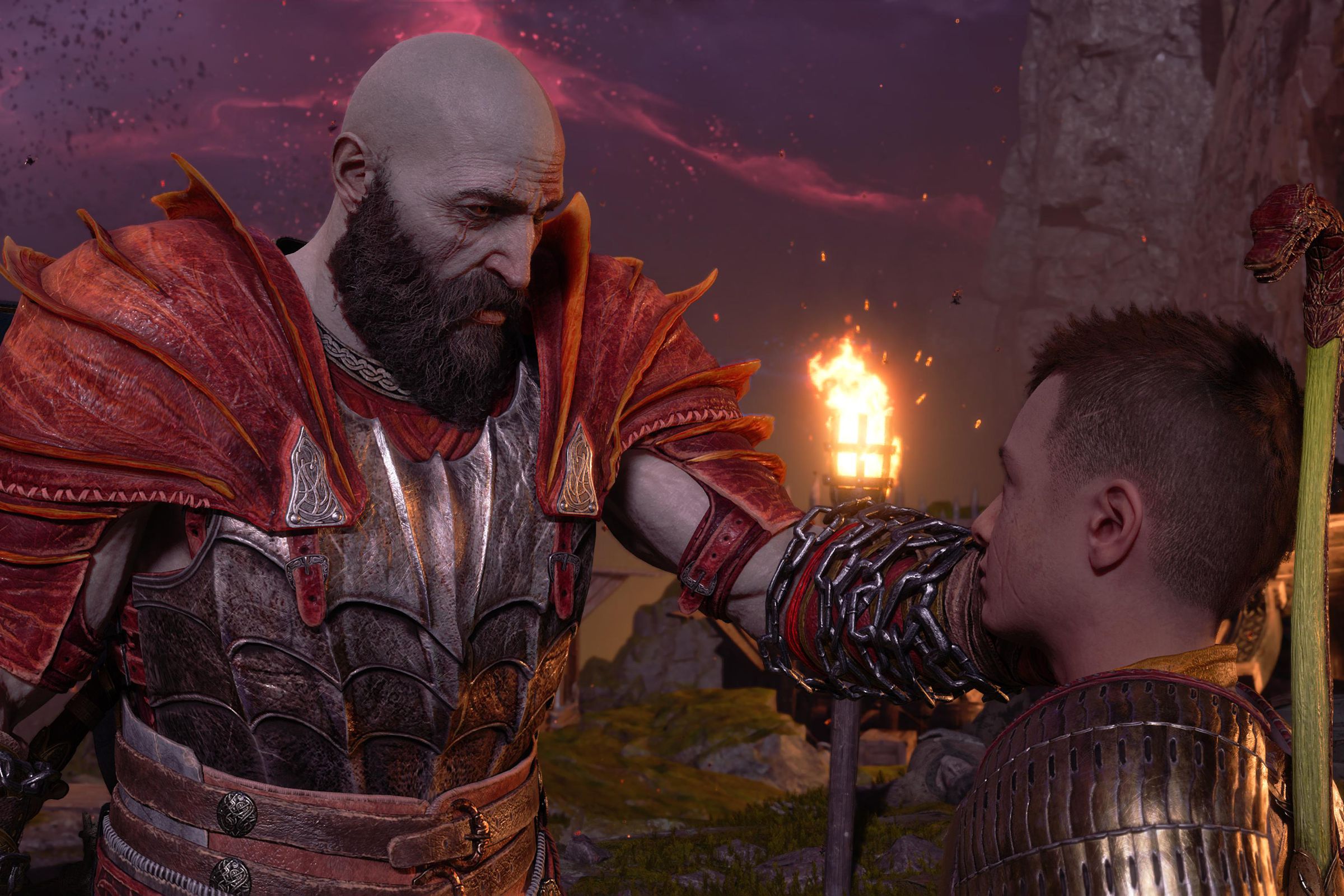 Screenshot from God of War Ragnarök featuring Kratos gently touching the face of his son, Atreus, in comfort