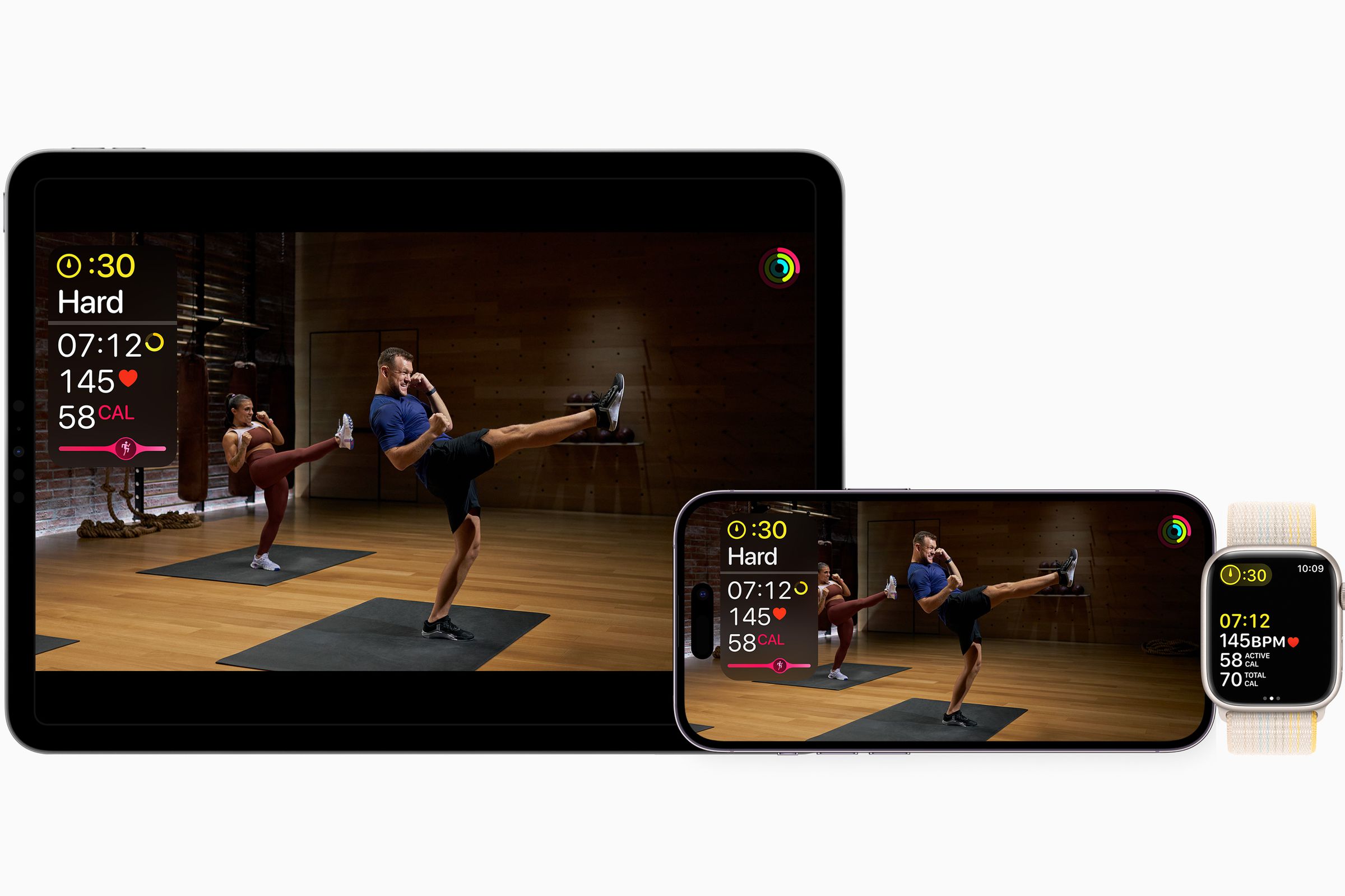 Kickboxing shown in the Fitness Plus app on an iPad and iPhone screen