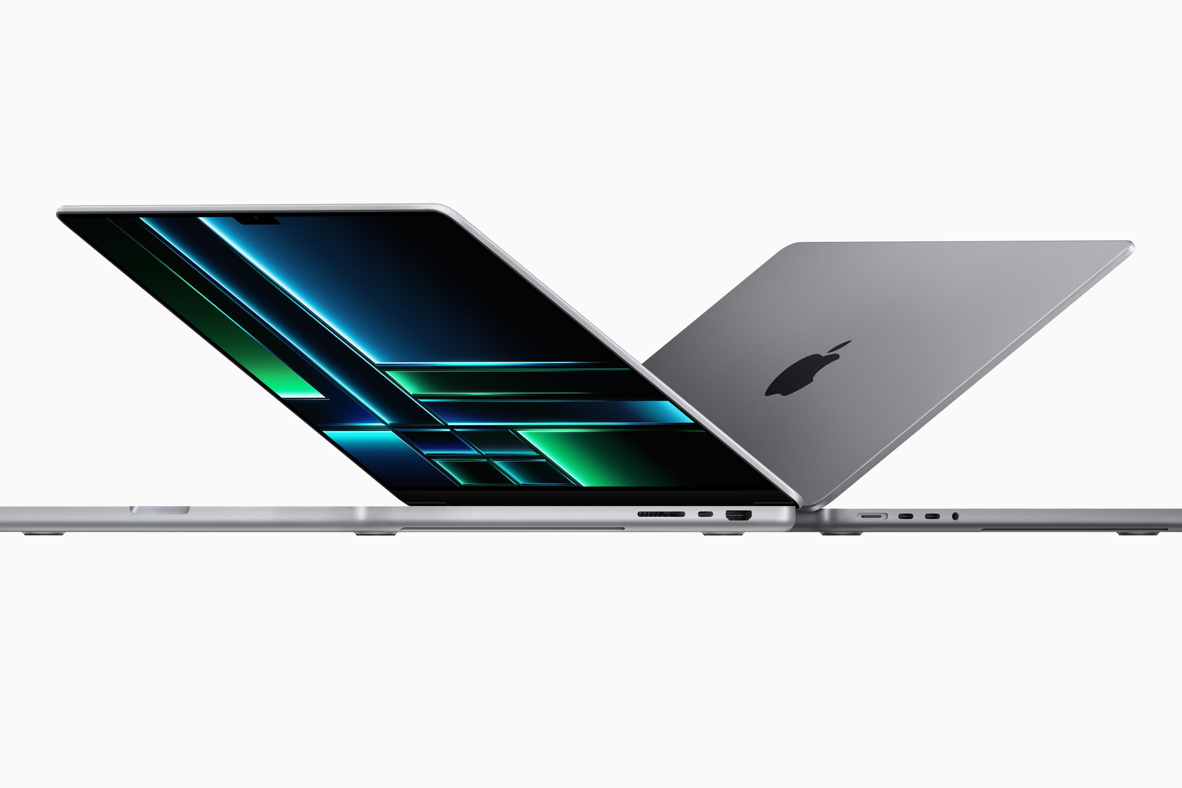 The silver 14-inch and 16-inch MacBook Pros sitting back-to-back, partially open on a white background.