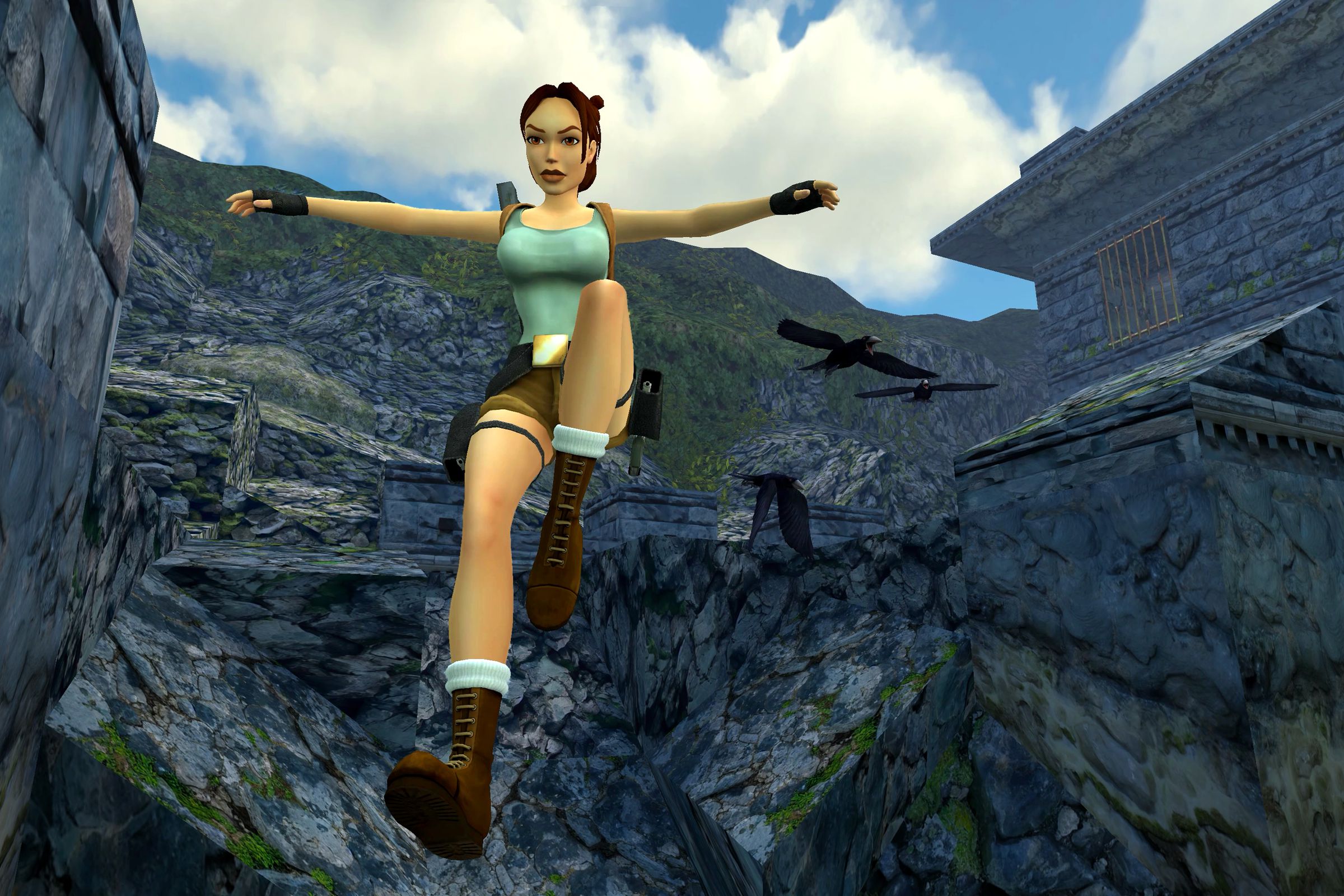 Screenshot from Tomb Raider 1-3 Remastered featuring Lara Croft jumping in the air with a mountain behind her.