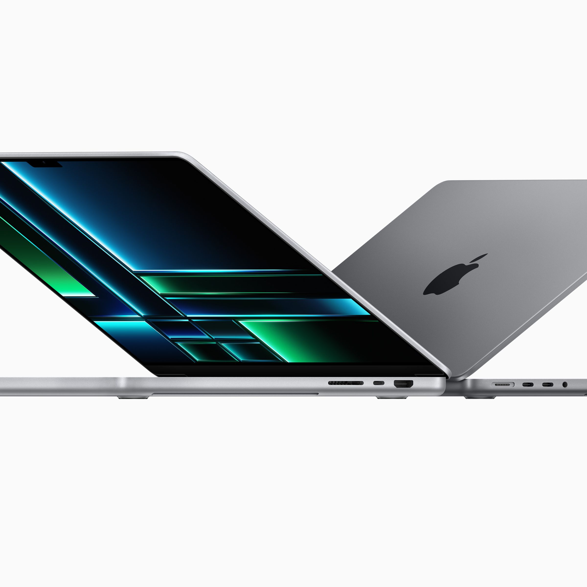 The silver 14-inch and 16-inch MacBook Pros sitting back-to-back, partially open on a white background.