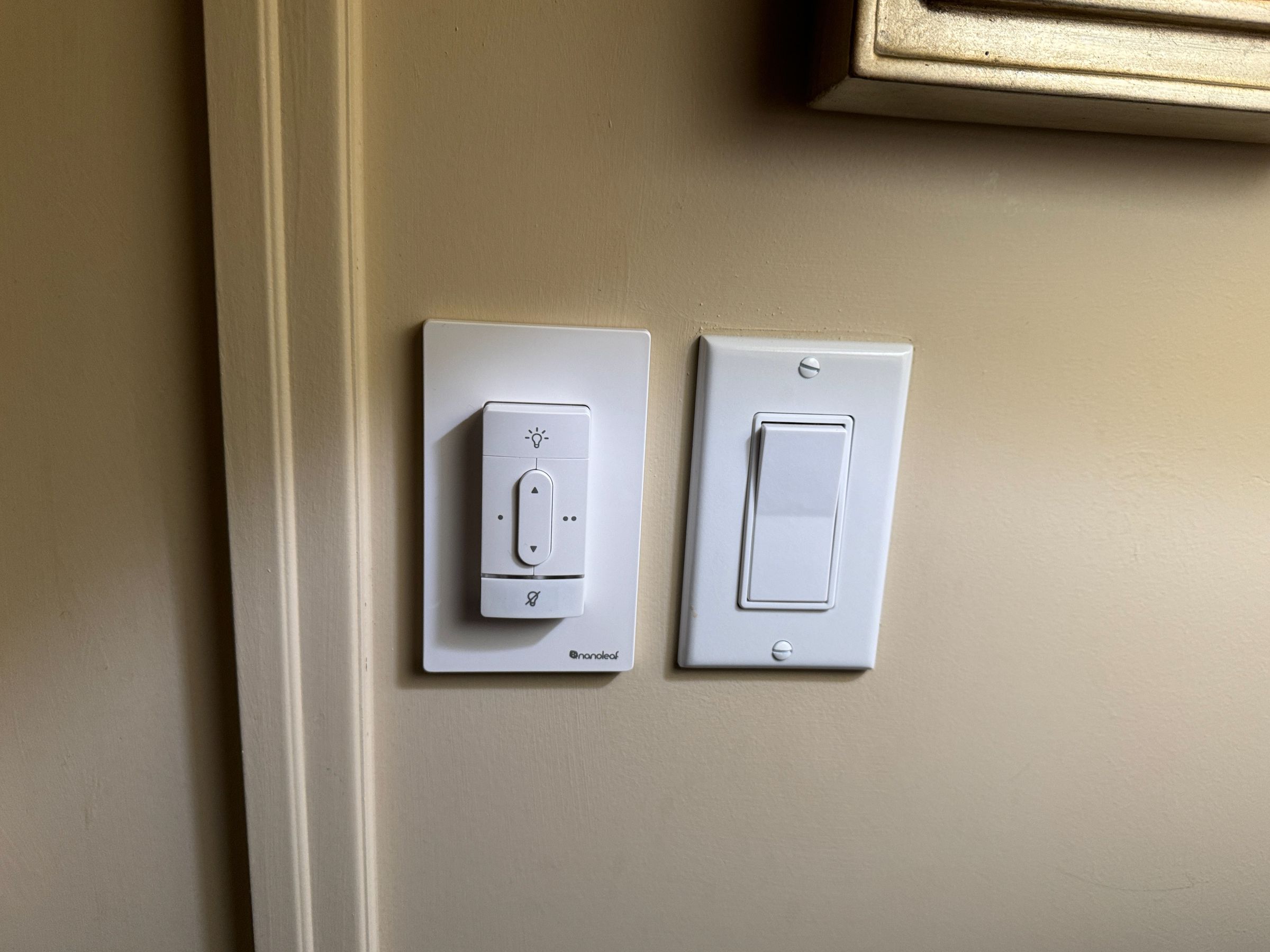 Nanoleaf’s new smart wireless switches (left, next to a standard switch) work over Thread and Matter and can be removed from the wall to act as a remote control. They are scheduled to arrive this summer.