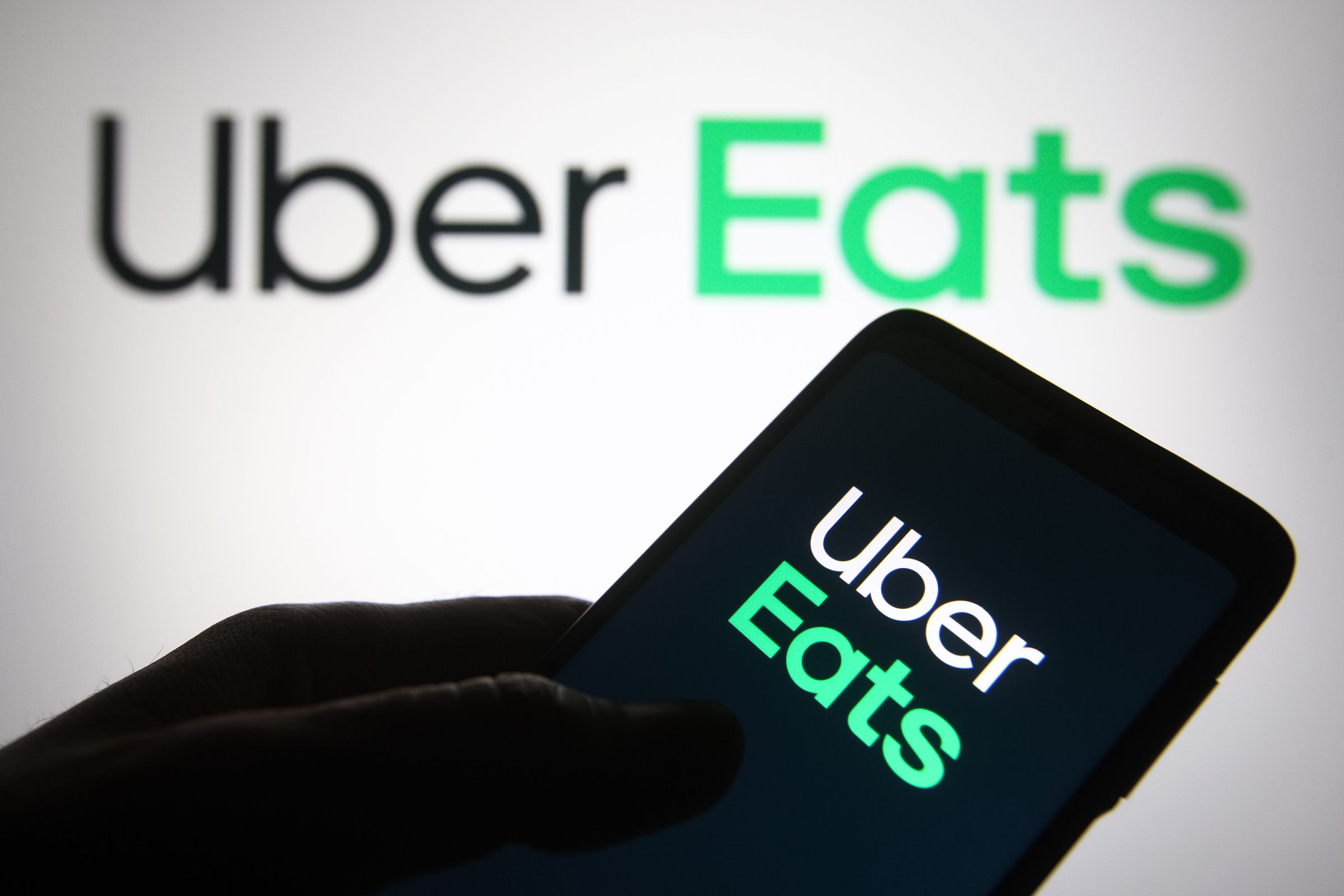In this photo illustration, Uber Eats logo of a US online...
