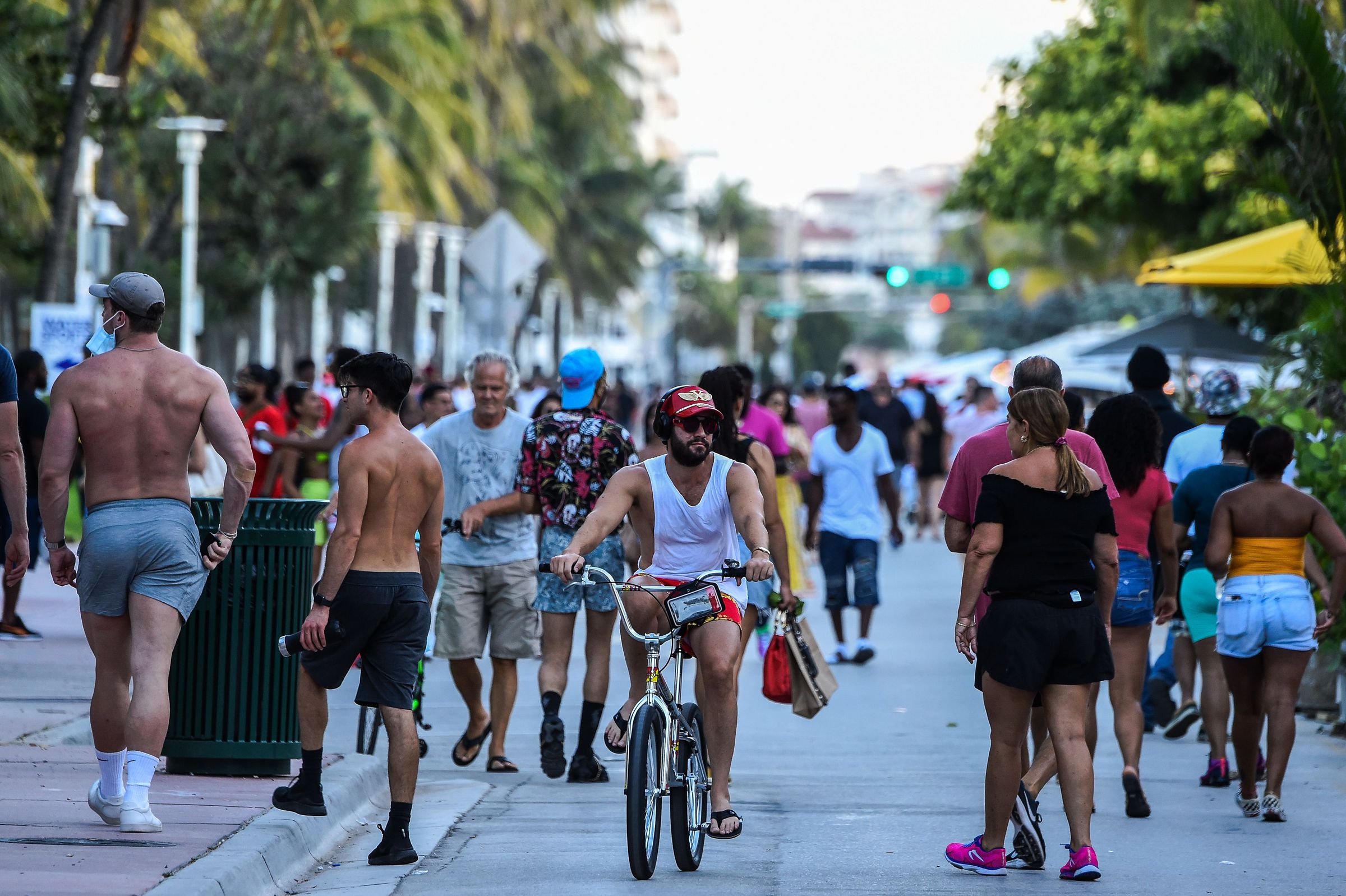 crowds of people walking in Florida, all without masks