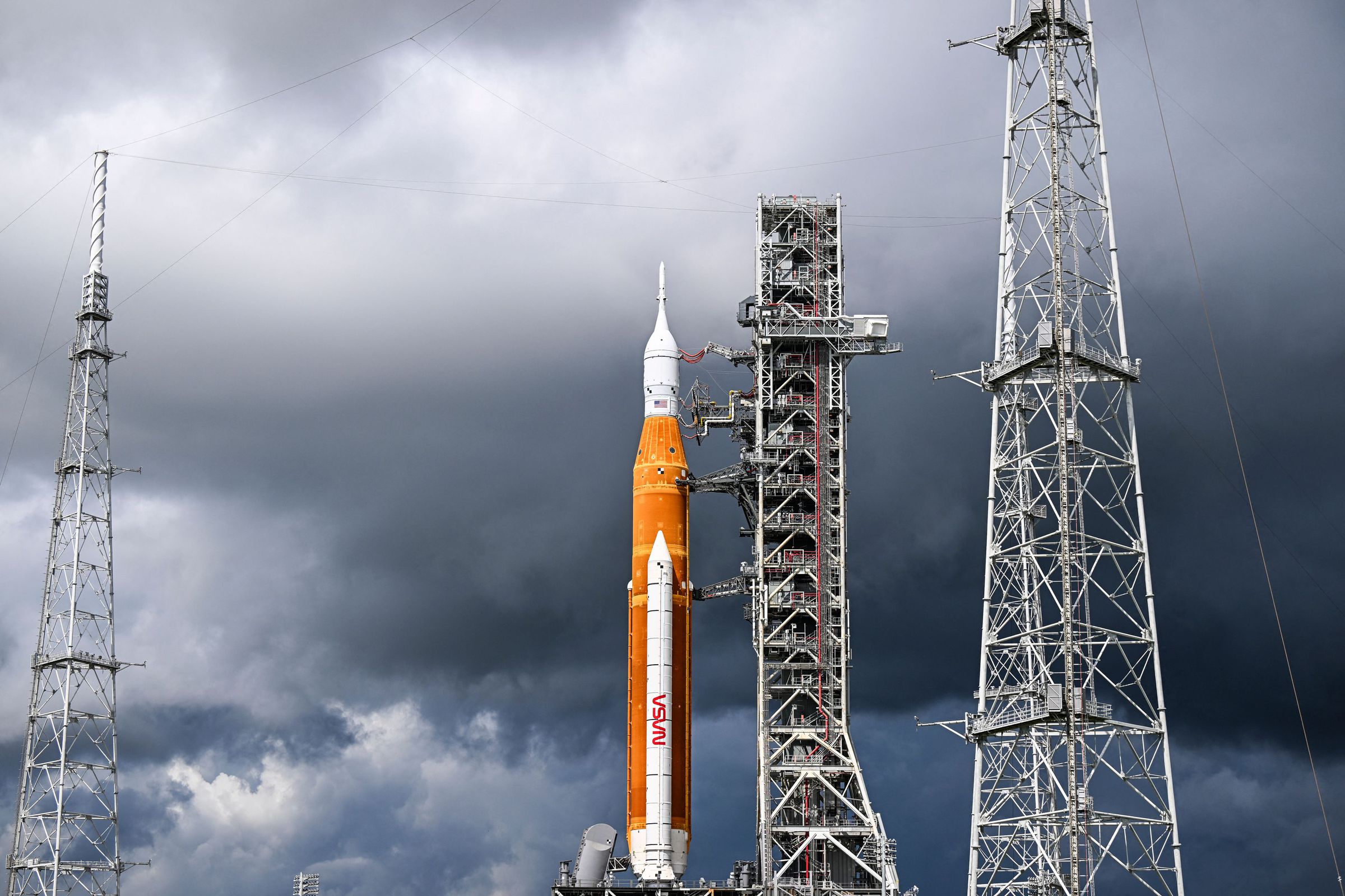 NASA’s Artemis I rocket with dark clouds in the background