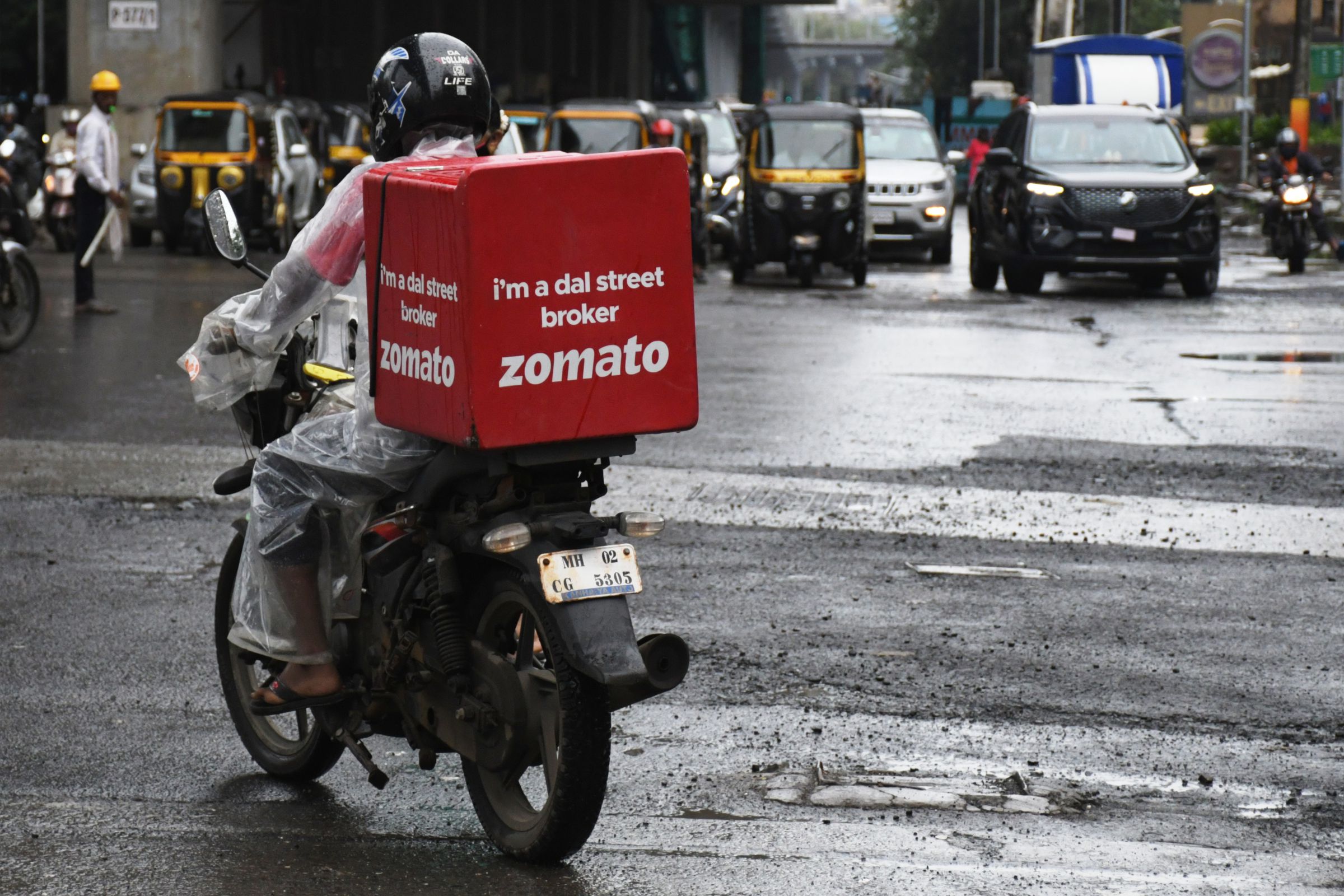 A Zomato delivery man seen riding along the streets of...