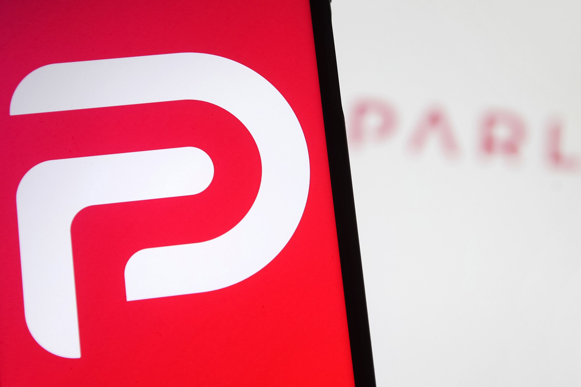 In this photo illustration the Parler logo seen displayed on...