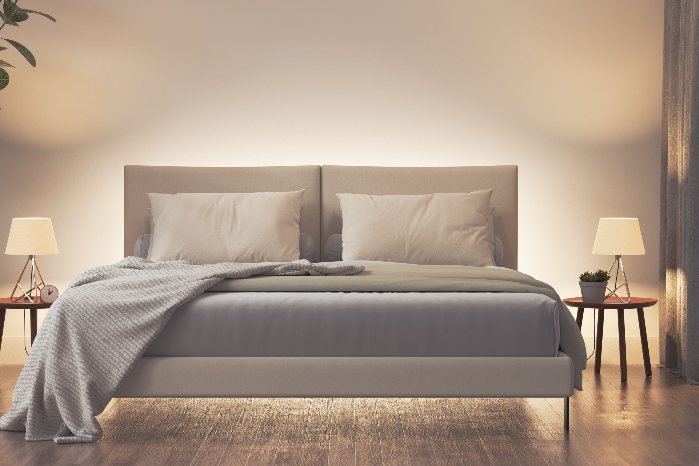 A bed with two lights on either side casting a gentle glow.