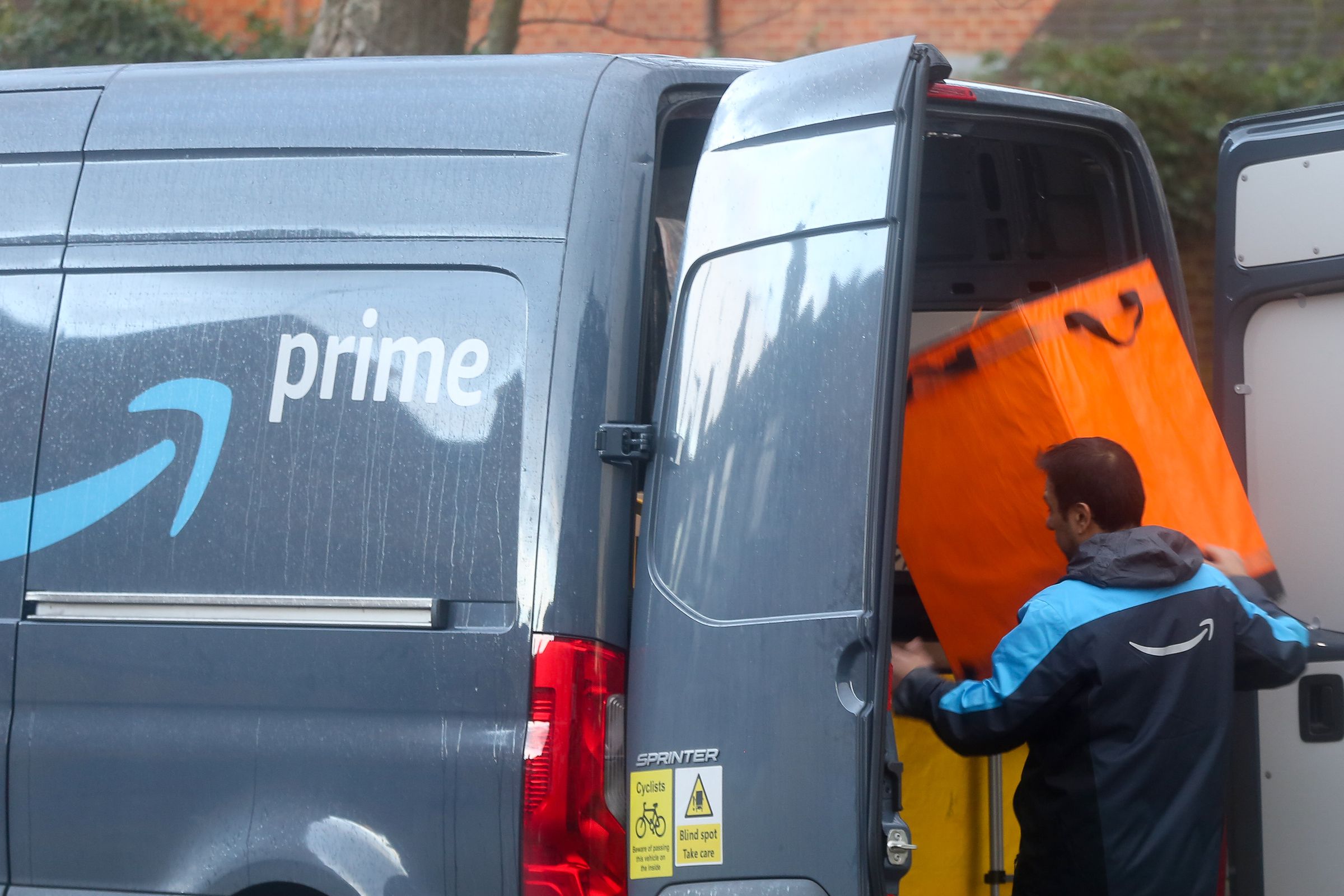 A driver of Amazon prime prepares for delivery in London...