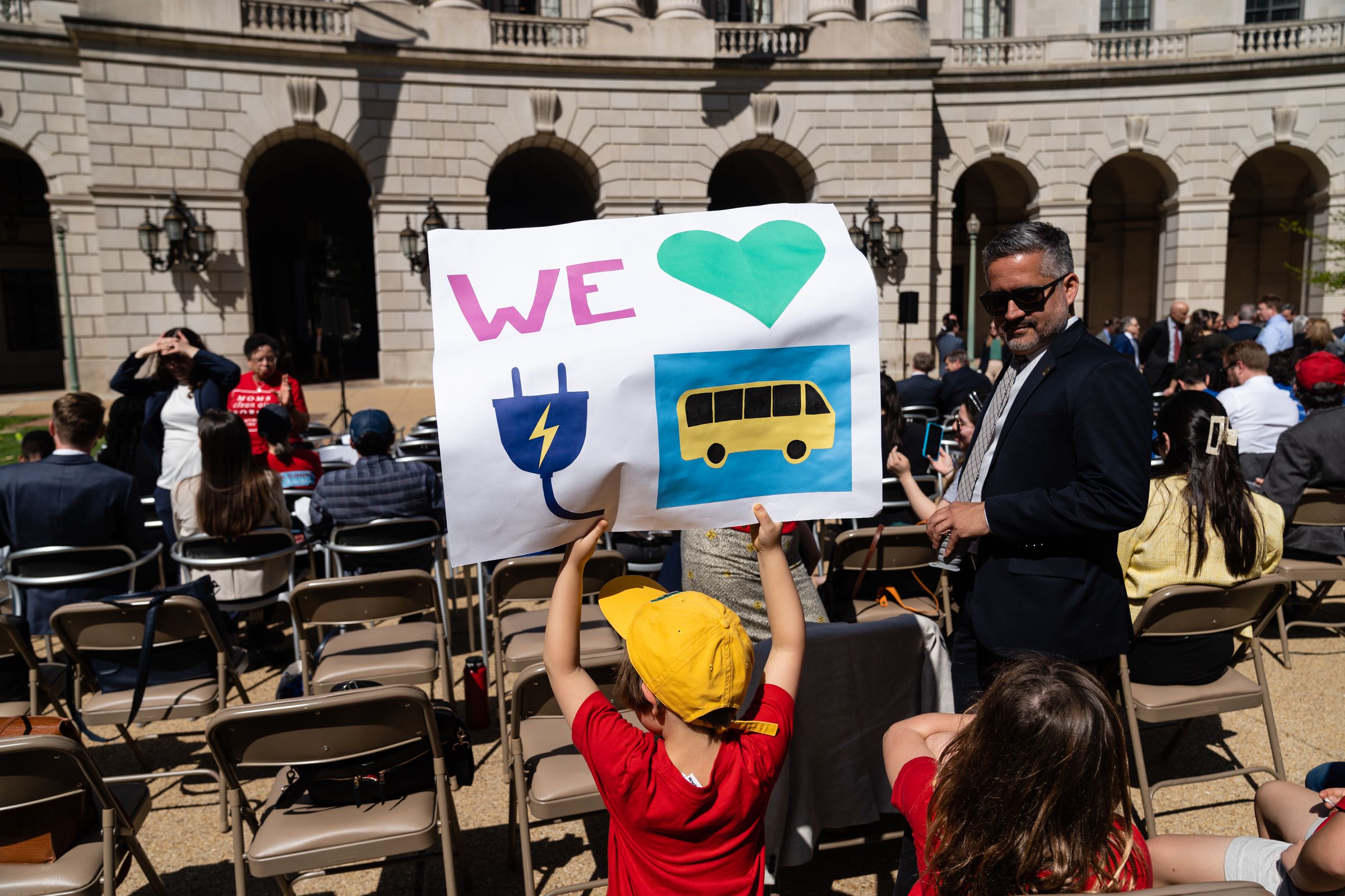 A child holds a sign during a news conference about a new tailpipe emissions rule from the EPA in Washington, DC, US, on Wednesday, April 12, 2023.