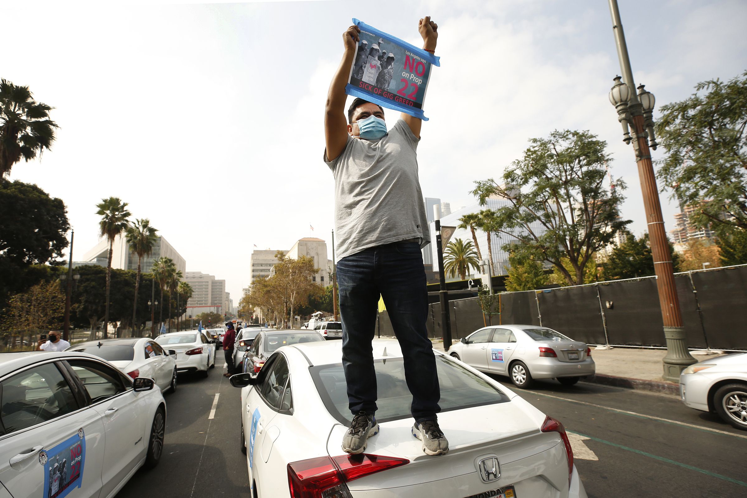 App based gig workers held a driving demonstration with 60-70 vehicles blocking Spring Street in front of Los Angeles City Hall urging voters to vote no on Proposition 22, a November ballot measure that would classify app-based drivers as independent contr