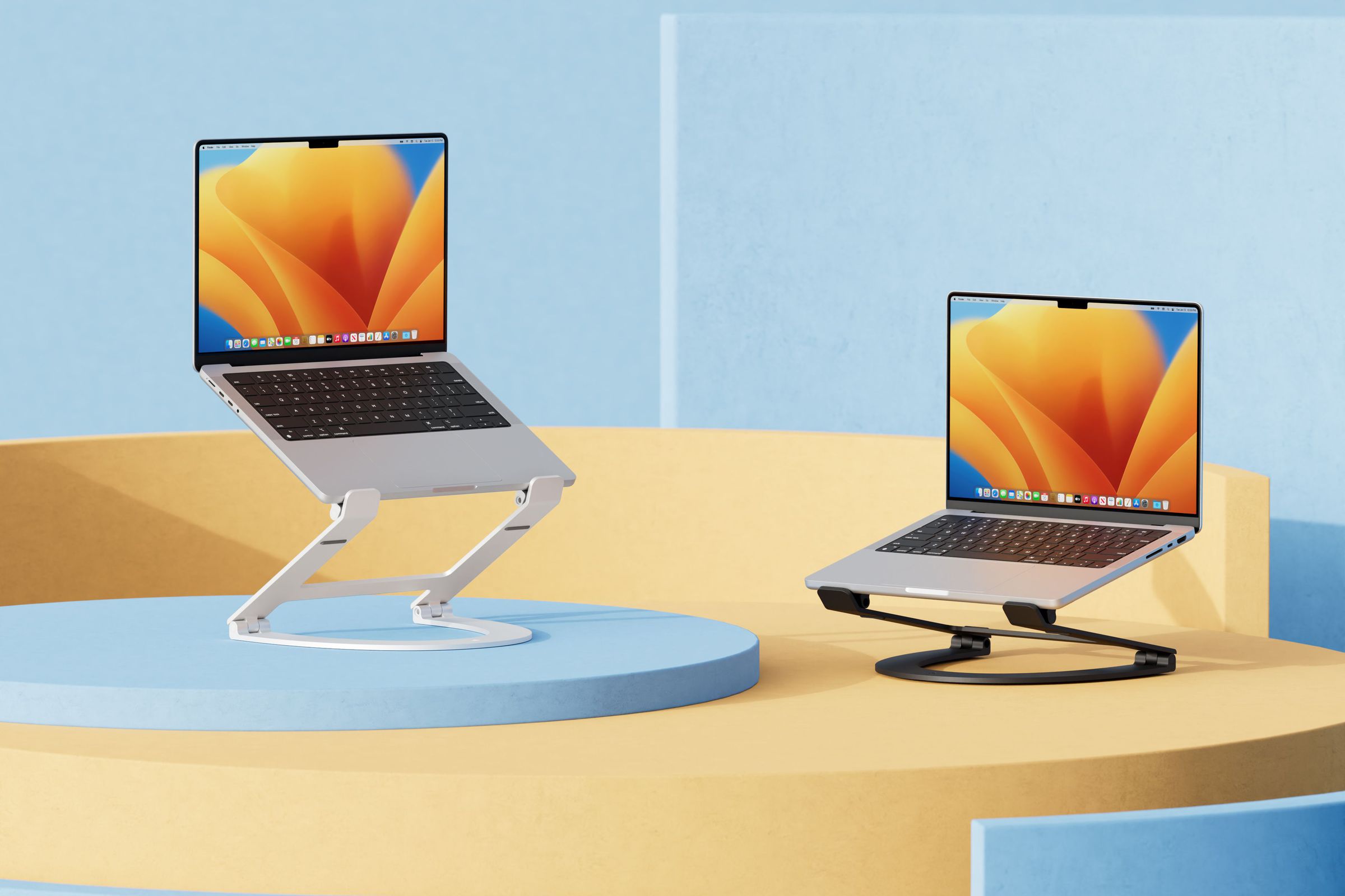 The Twelve South Curve Flex laptop stand in matte white and matte black with two MacBook laptops&nbsp;