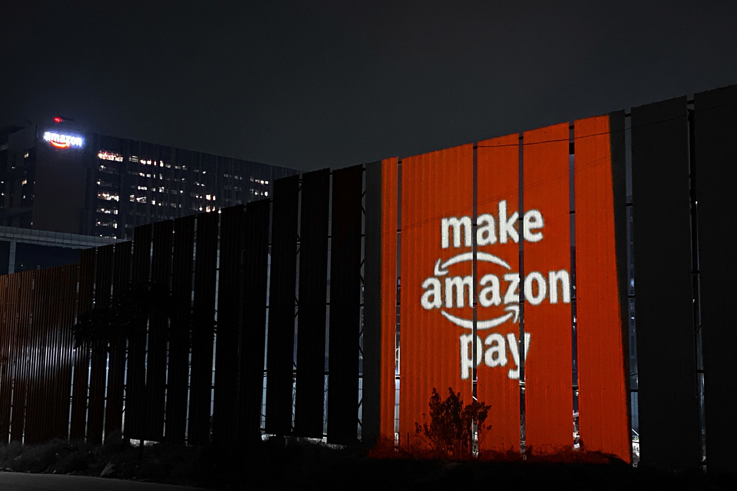 The “Make Amazon Pay” logo projected onto Amazon’s campus in Hyderabad, India.