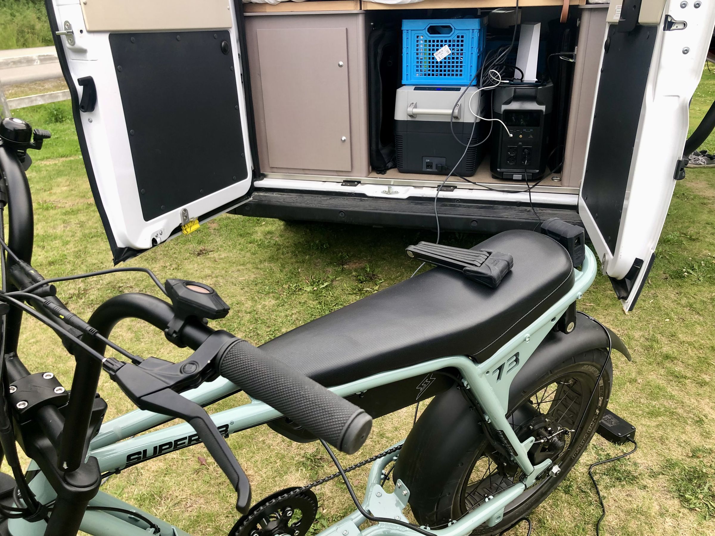Charging a Super73 e-bike with the battery still connected. The 400W solar panel is slotted into the van to the right of the Delta Pro.