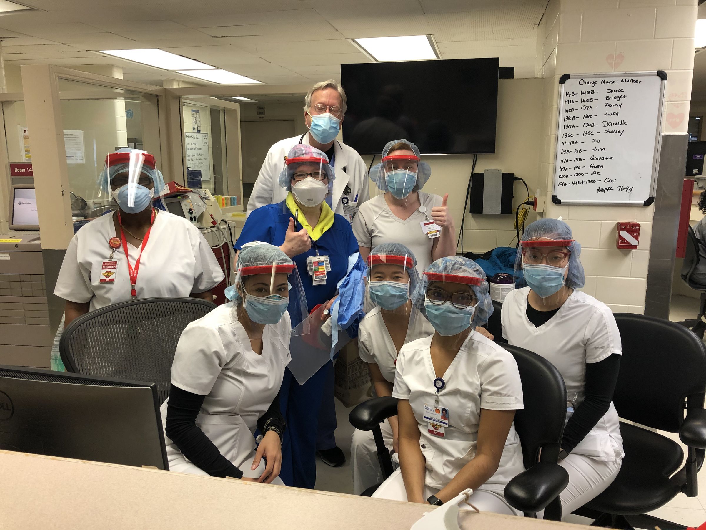 Dr. Stephen Nicholas with fellow doctors, nurses, and staff at Harlem Hospital wearing COVID Maker Response face shields. 