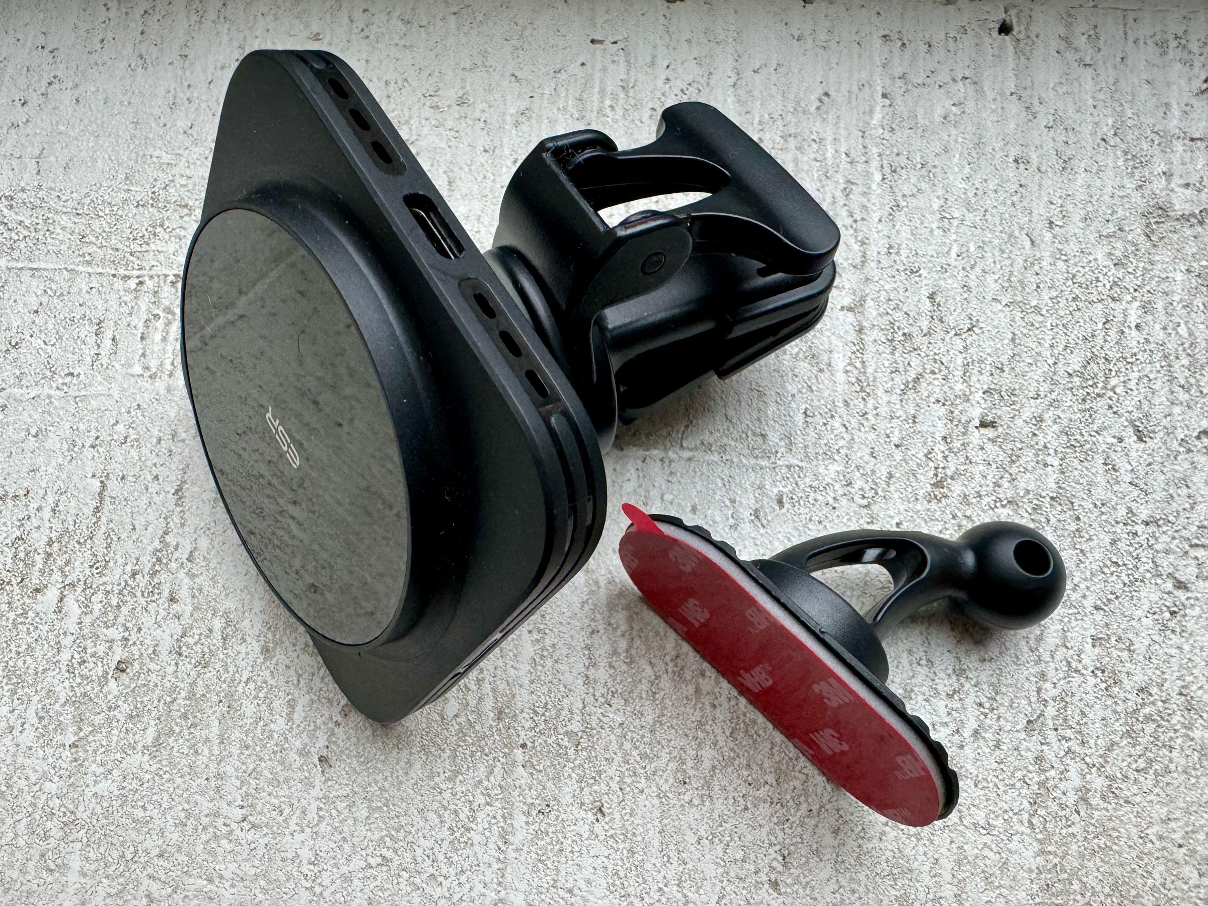 ESR includes two mounts in the box: the air vent clip (shown attached to the charging puck) and a flexible 3M adhesive mount that conforms to the shape of your dashboard.